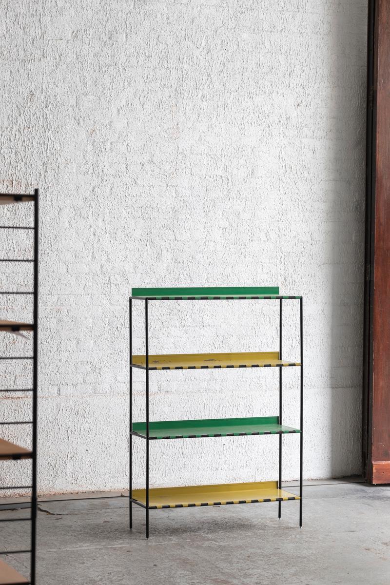 Abstracta shelving unit designed by Poul Cadovius and produced in Denmark around 1960. This unit consist of black lacquered steel pipes with green and yellow metal plates. In decent condition with some corrosion on the shelves as shown in the