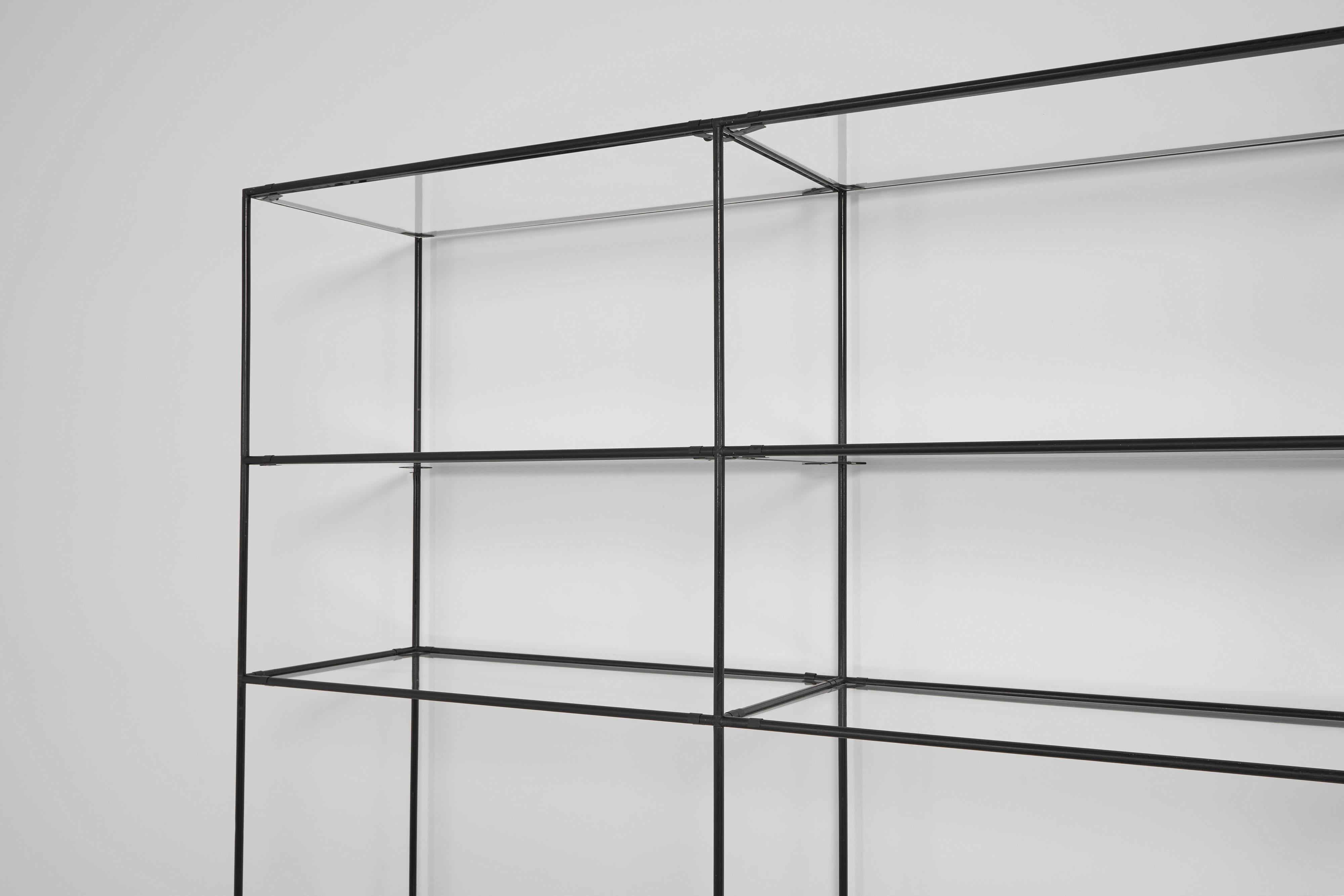 Very nice minimalistic shaped and so called ‘Abstracta’ shelving system designed by Poul Cadovius and anufactured by Royal System, Denmark 1960. This timeless system exists of black lacquered metal tubes with cast aluminium connectors, clear glass