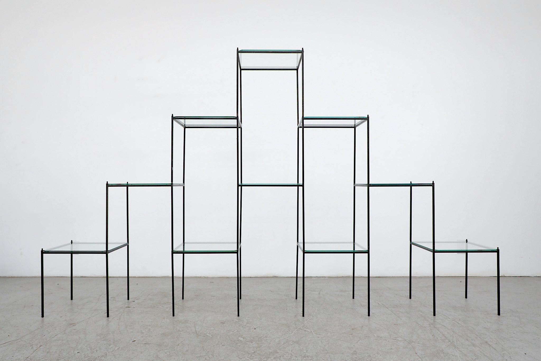 Incredible, Mid-Century standing shelving unit or room divider. Reminiscent of Poul Cadovius' 'Abstracta' system. Ten rearrangeable and stackable black enameled metal frames with glass tops. Elegant and versatile display system perfect for books,