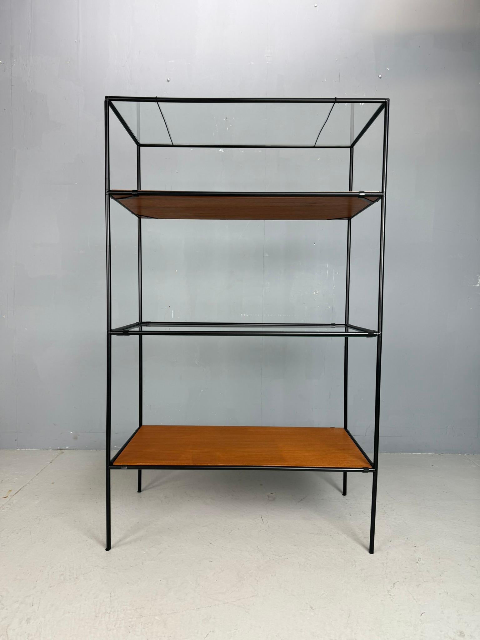 Minimal Danish modular display shelving by Poul Cadovius — Abstracta System, 1960s.
A beautiful early example of Cadovius’ iconic Abstracta shelving system, featuring black-lacquered metal tubes with cast aluminium connectors, paired with teak and