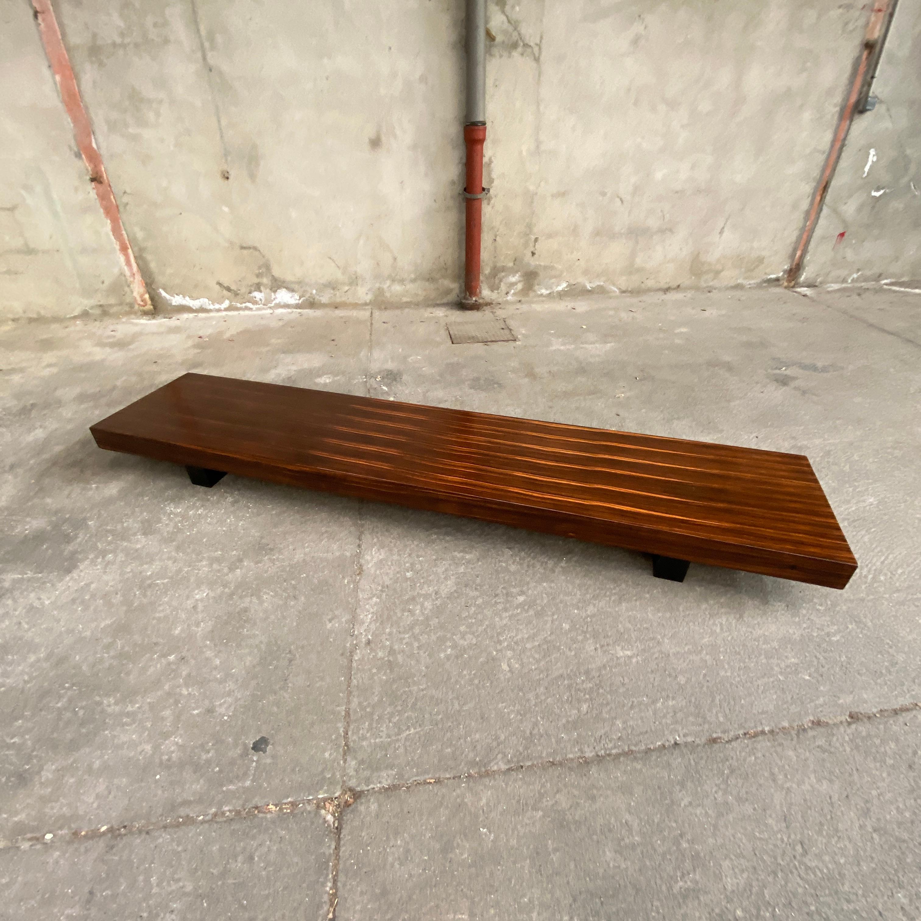 Poul Cadovius bench coffee table in rosewood, base lacquered in black. Rare and original piece in very good condition.
  
