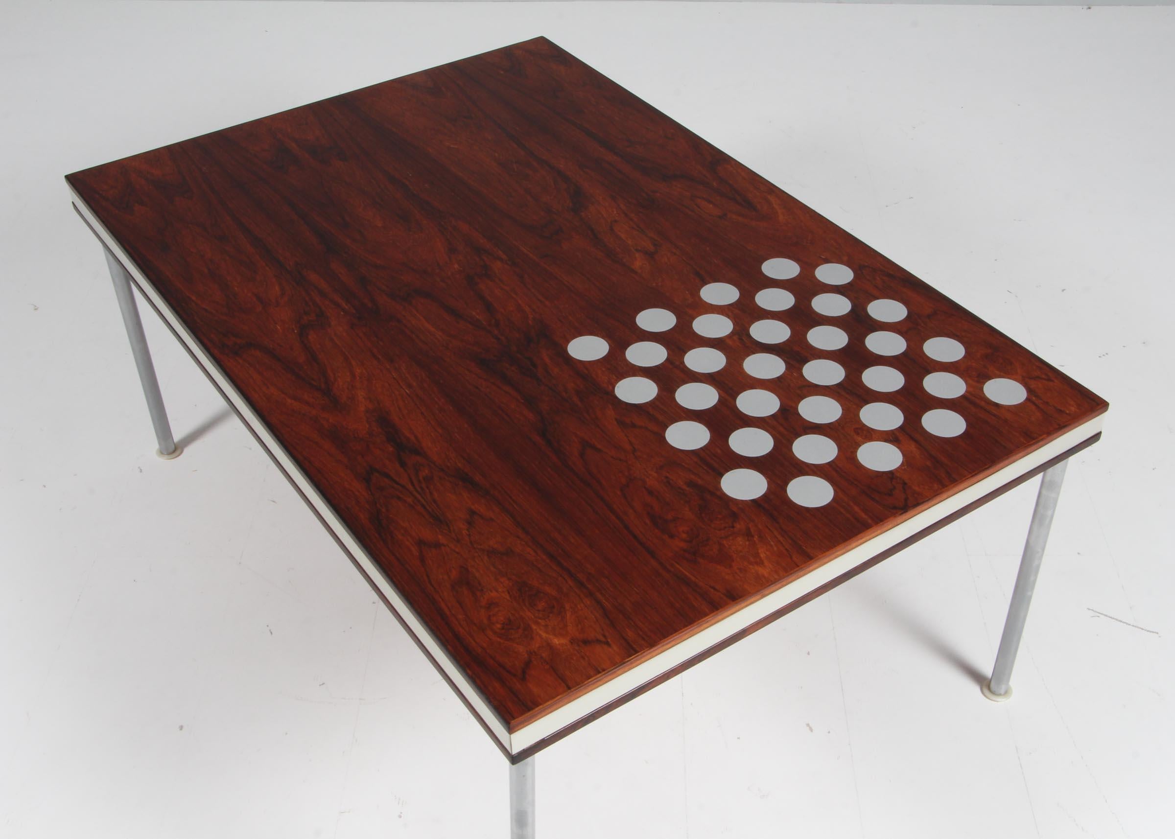 Poul Cadovius coffee table in veenered rosewood, steel details.

Made by France & Son.