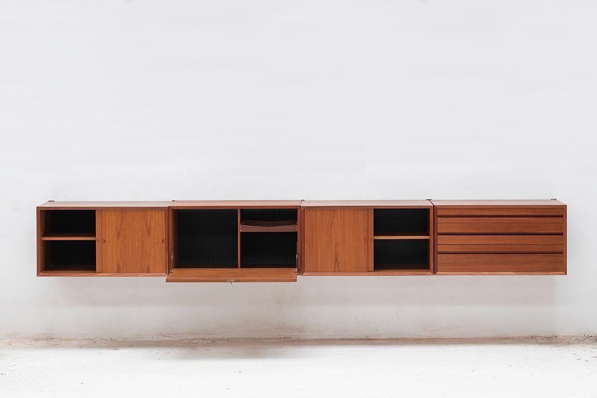 Floating sideboard designed by Poul Cadovius and produced in Denmark around 1960. This set features 4 different cabinets which can be arranged in any order. They come with 5 short teak wooden wall rails to attach them to the wall. In good condition