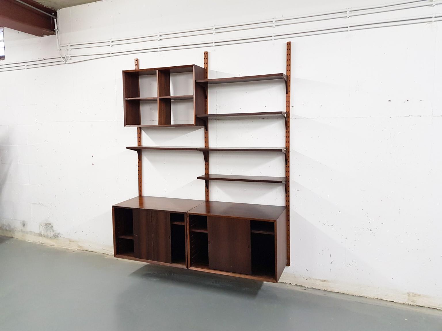 Beautiful rosewood veneer wall unit by Poul Cadovius for CADO. The wall unit consist of two cabinets with sliding doors, one cabinet which is open at the back and five book shelves

Poul Cadovius
When you ask someone to think of an European