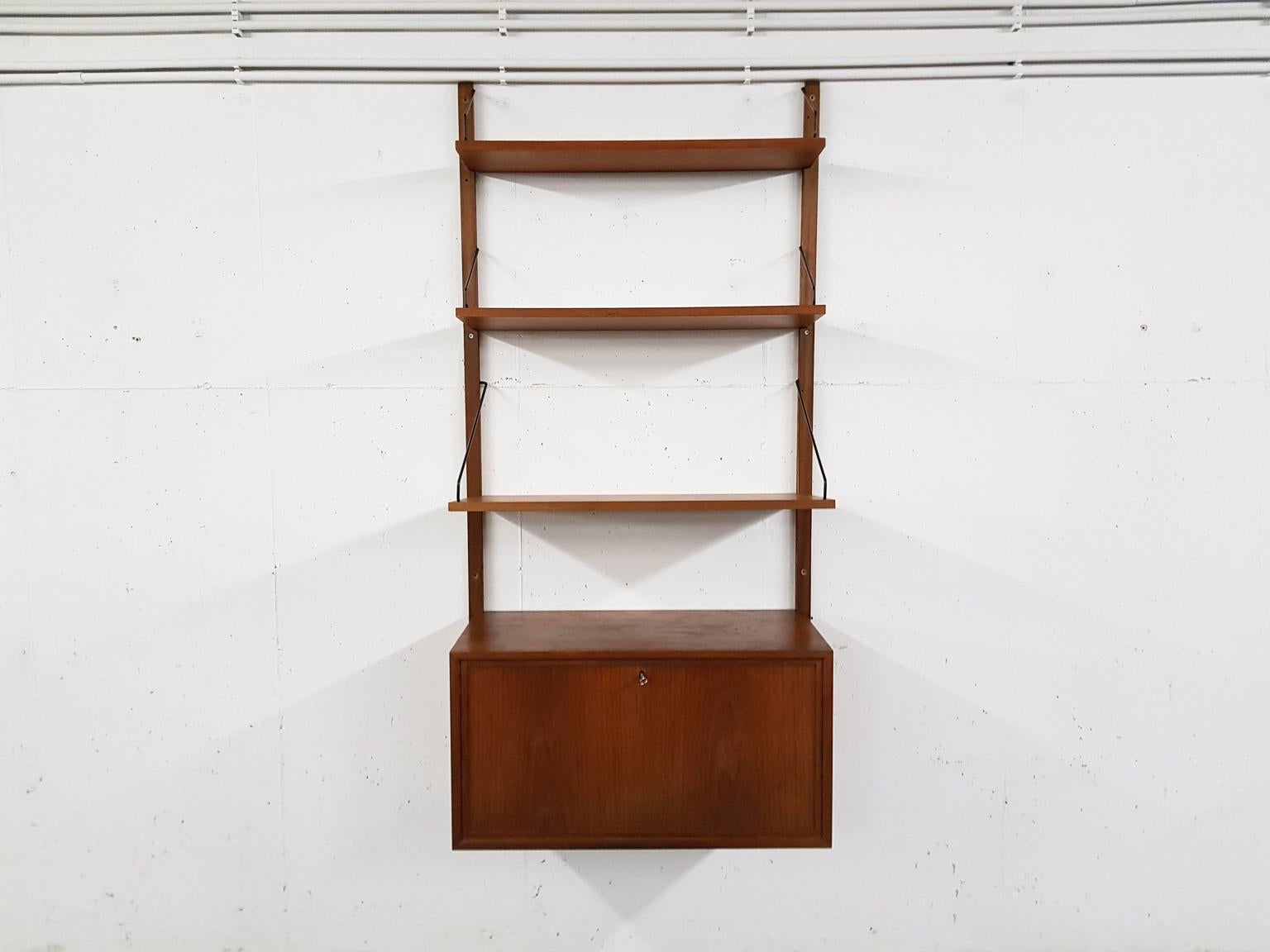 Danish design wall system or shelving unit with a dry bar by Poul Cadovius for Royal System, designed in Denmark in 1948.

This item has a dry bar or cabinet, which features a mirror, bottle rack and interior light.

When you ask someone to