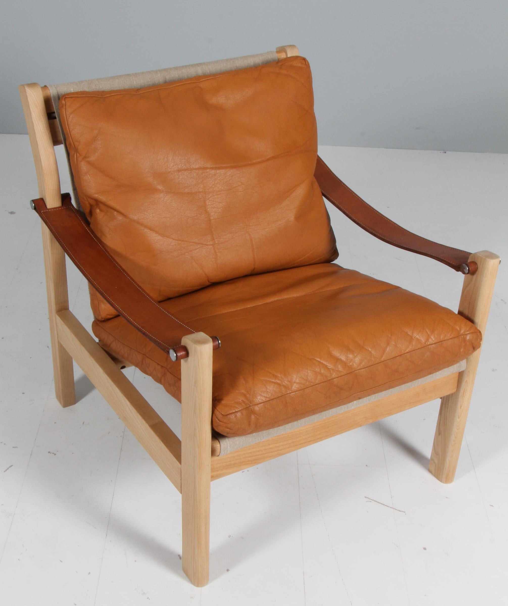 Poul Cadovius lounge chair with frame of ash. 

Seat and back with canvas, original upholstered tan leather cushions.

Made by Cado.