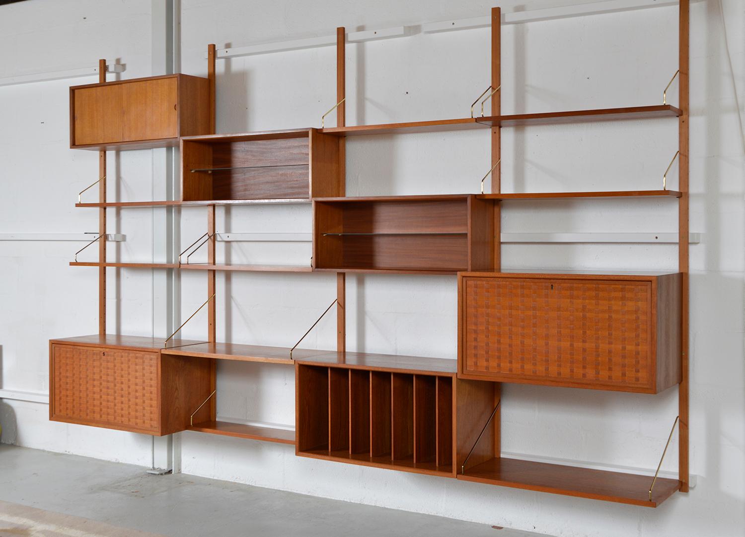 This highly versatile and functional “Royal System” was originally designed by Poul Cadovius in 1948. This large four bay teak shelving system offers a wide variety of storage and display options - as seen rearranged in our images. The two