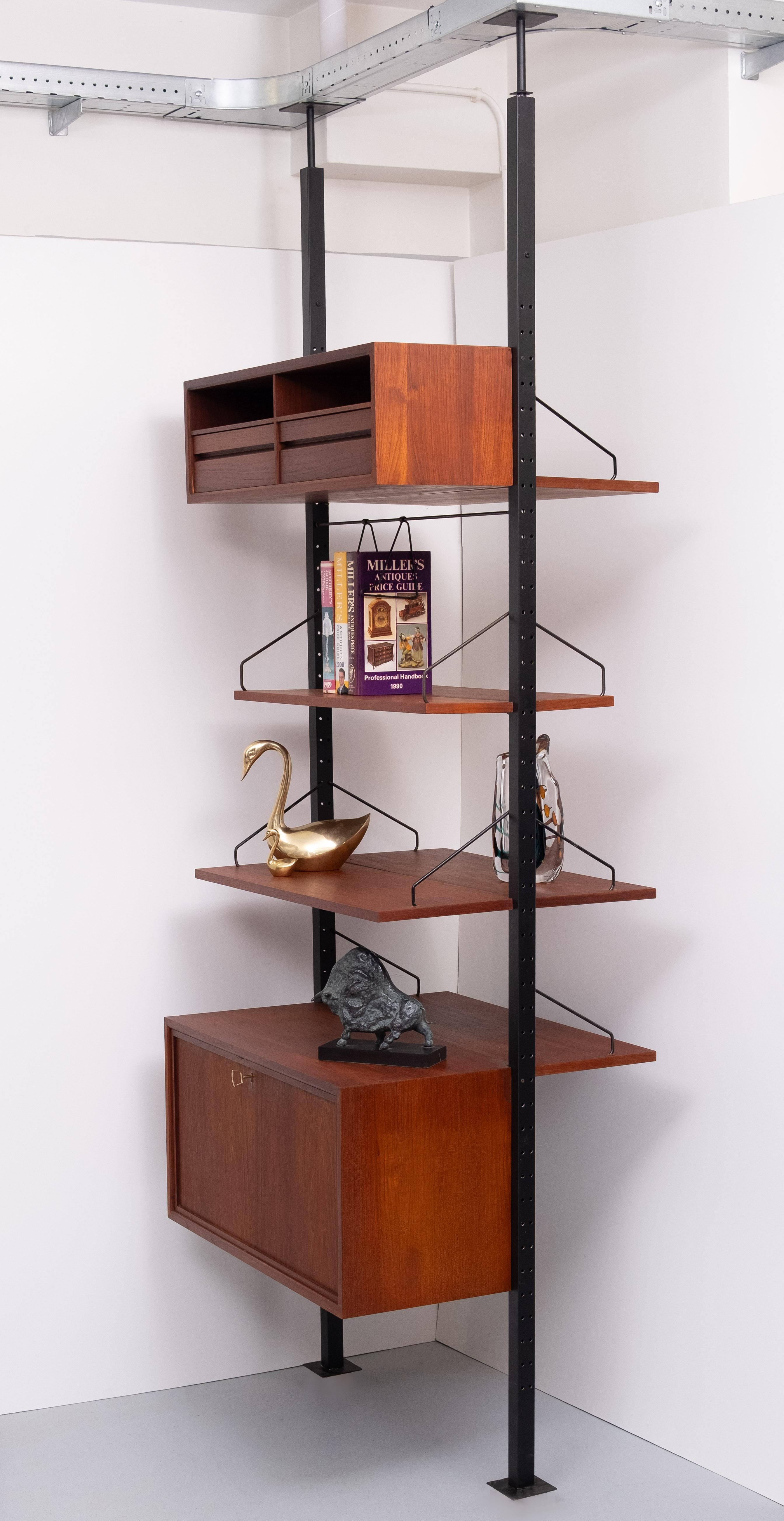 For sale this very exclusive and rare poul cadovius  room divider comes with 2 Steel telescopic legs, works with a spring .so is adjustable in height .
can be used on both sides .comes with a super rare book stand ,integrated 
in the system . 6