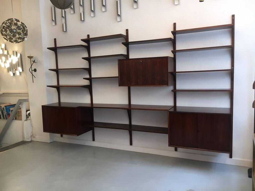 Royal shelving system by Poul Cadovius produced by Cado, Denmark, circa 1960
Rosewood, very good condition, original color, entirely modular system.

- 10 shelves 80 x 22 cm
- 3 shelves 80 x 22 cm
- 2 shelves 80 x 38 cm
- 2 sliding doors