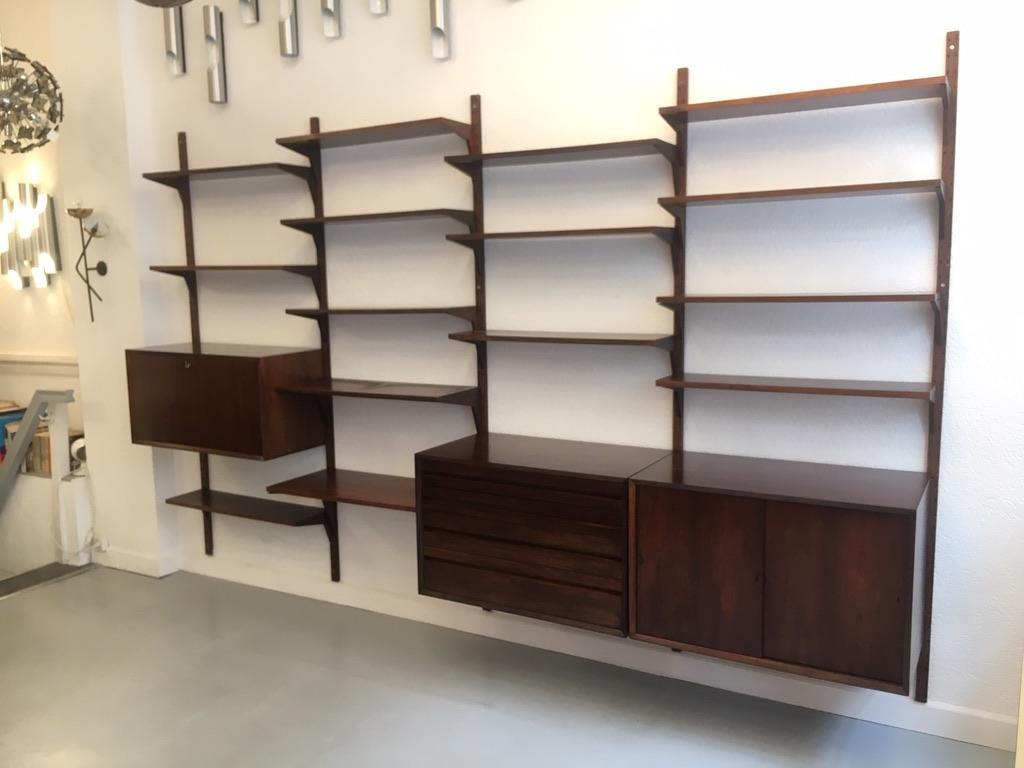 Royal Shelving System by Poul Cadovius produced by Cado, Denmark circa 1960
Rosewood, very good condition, original color, entirely modular system.

- 10 shelves 80 x 22 cm
- 1 shelf 80 x 30 cm
- 1 shelf 80 x 38 cm
- 1 drawers cabinet
- 1