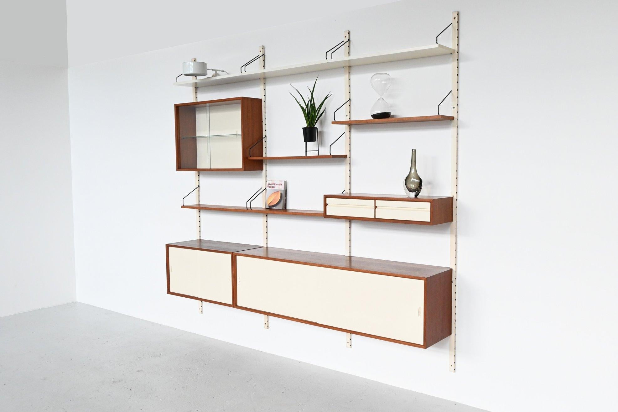 Beautiful large Royal System wall unit designed by Poul Cadovius for Cado, Denmark 1960. This highly versatile and functional wall system offers a variety of storage and display options. It is made of veneered teak in combination with white