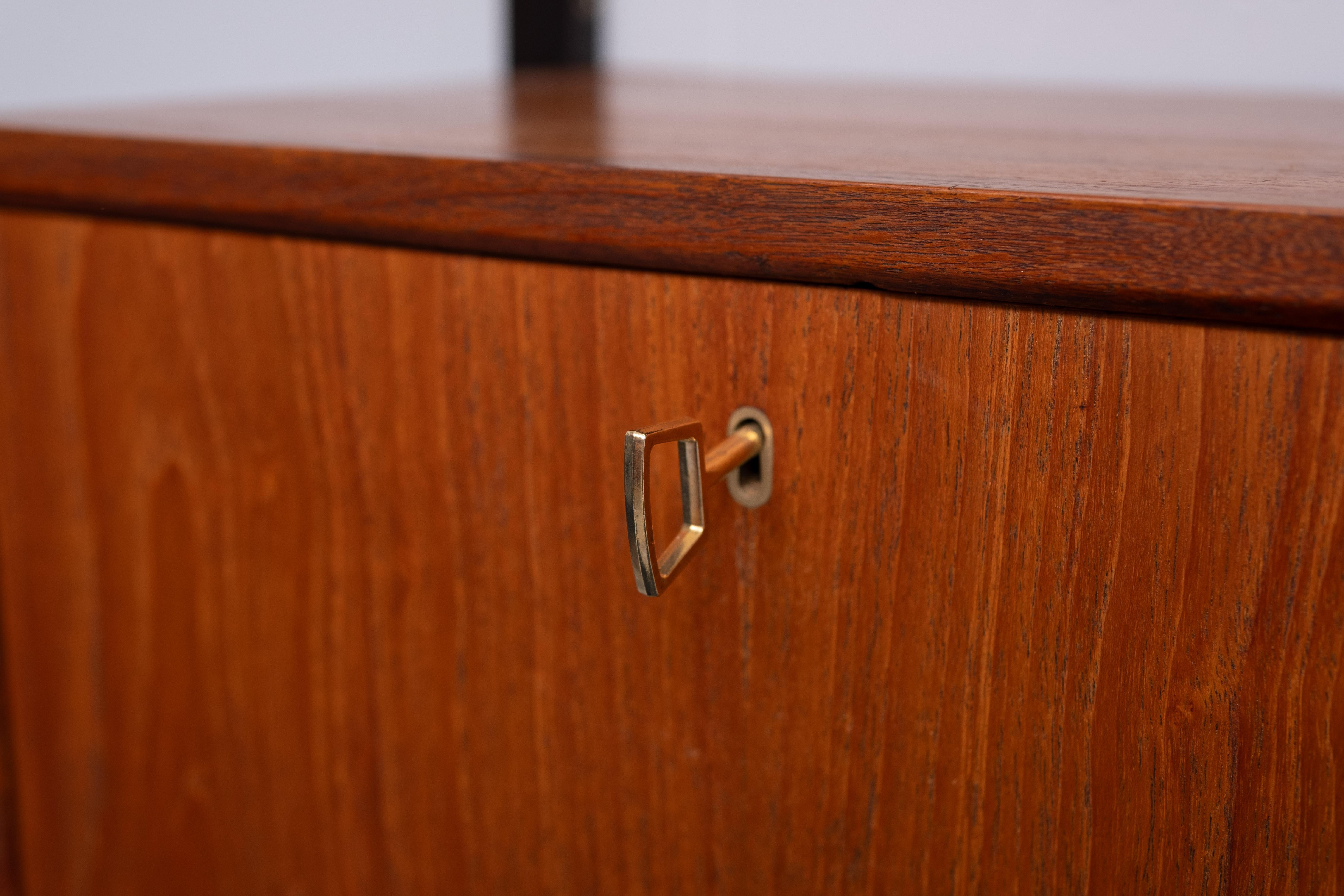 Poul Cadovius  for Royal system . Hanging  wall system .new Glass doors .
3 uprights . 2 Cabinets and 6 shelves . Teak .and al the hardware .
can be changed in every position you want . Ideal for smaller houses . 