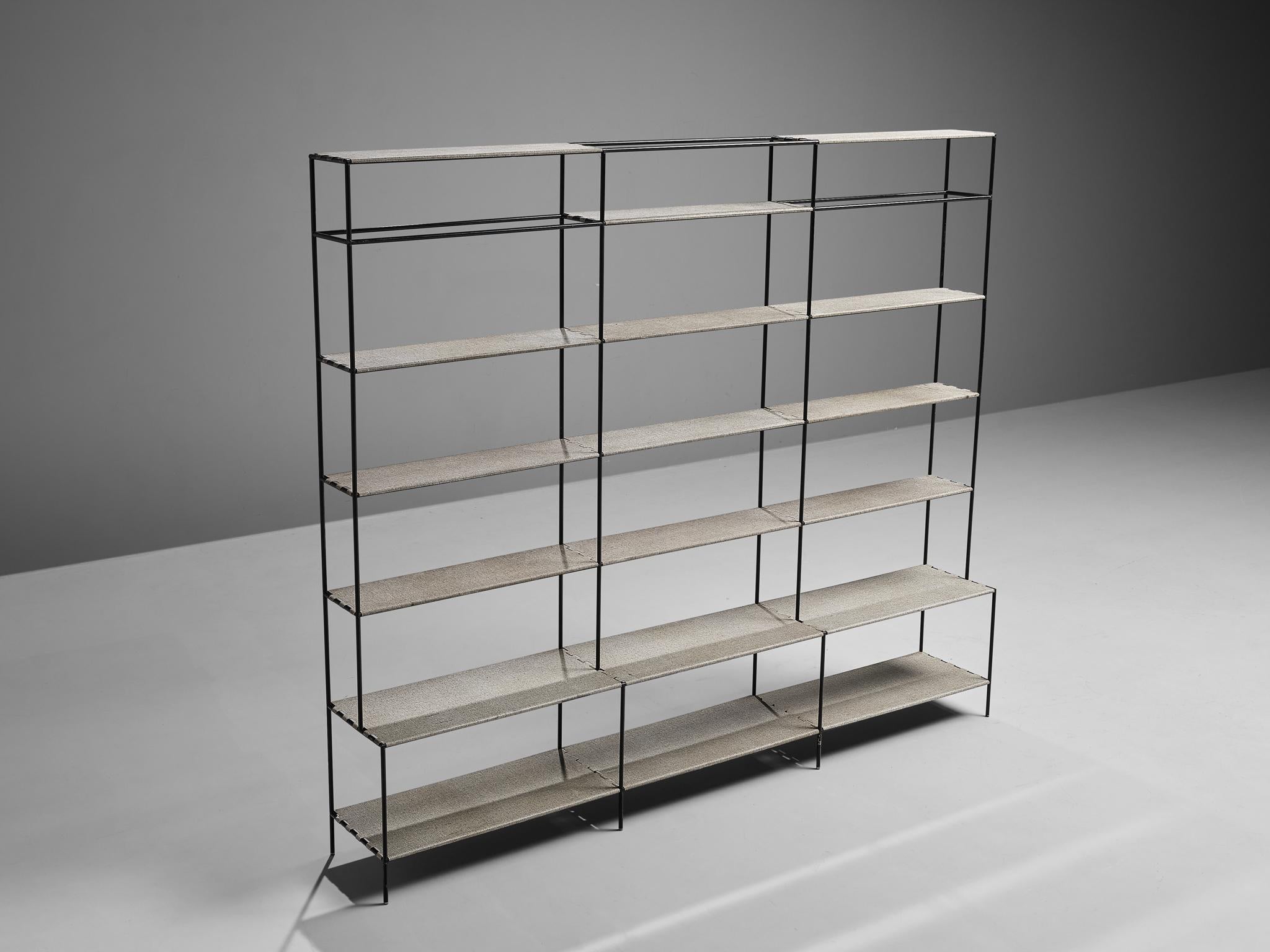 Poul Cadovius, open bookshelf or room divider, metal, Denmark, 1960s

This minimalist shelving unit was designed by Poul Cadovius. This shelving system exists of a thin frame in black metal to which shelves can be attached. Three open columns with a