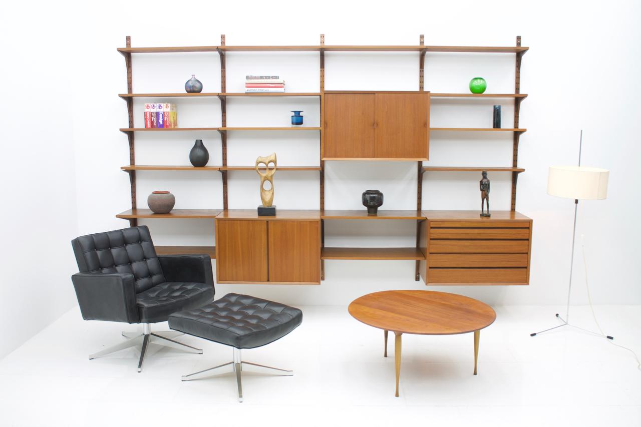 Large teak shelving system by Poul Cadovius for Cado, Denmark, 1956.
1 x teak cabinet with 4 drawers
1 x teak cabinet with two folding doors
1 x teak cabinet with two sliding doors
4 x shelves 80 x 40 cm.
13 x shelves 80 x 20 cm.
5 x wall