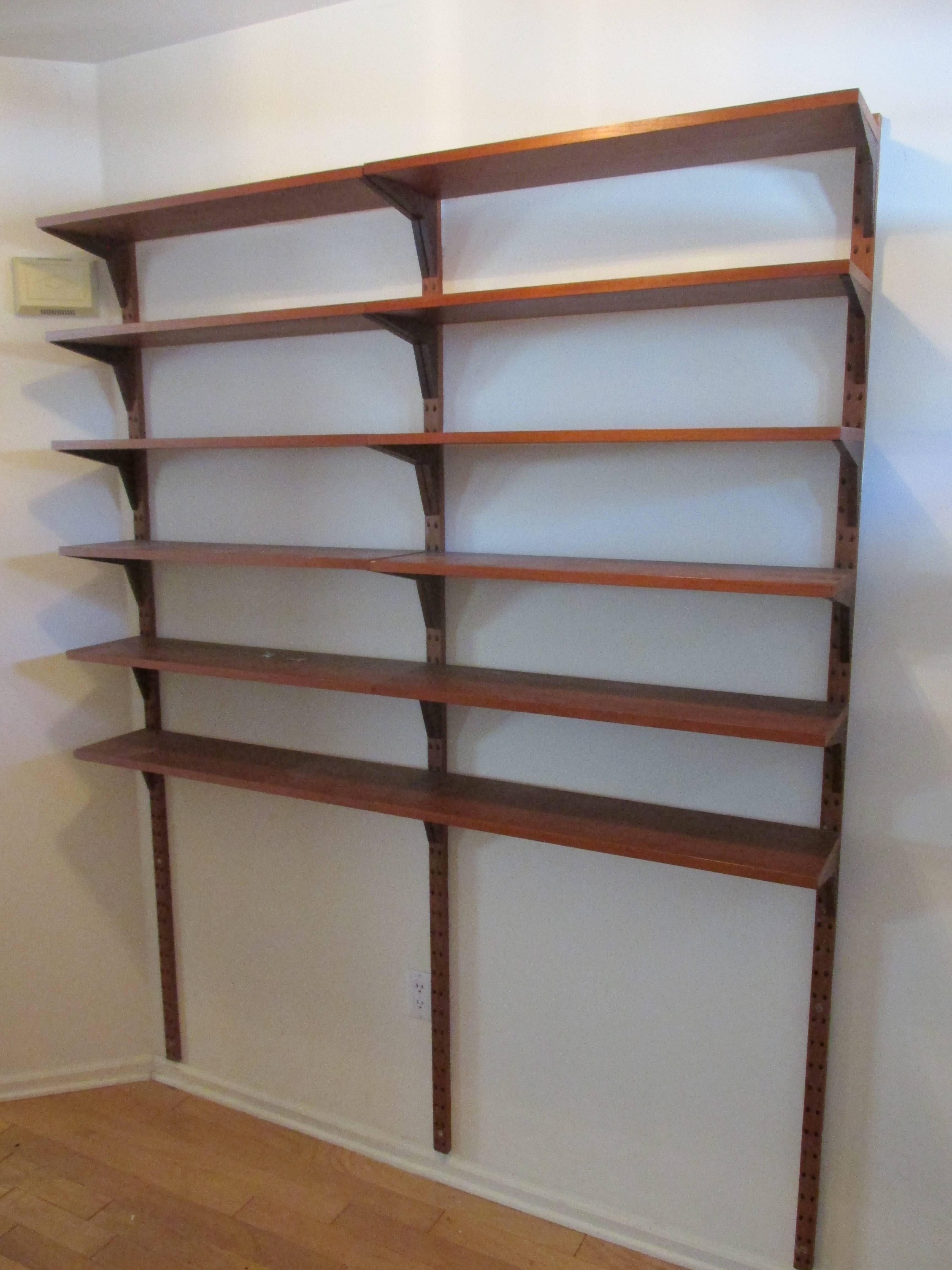 Poul Cadovius shelving unit in teak with 16 shelves each 31.5 x 8.75 deep supported by three large 79.5 inch stanchions and 32 brackets price as shown in primary picture is $2400. In addition to this unit there are available one large 31.5 x 18 deep