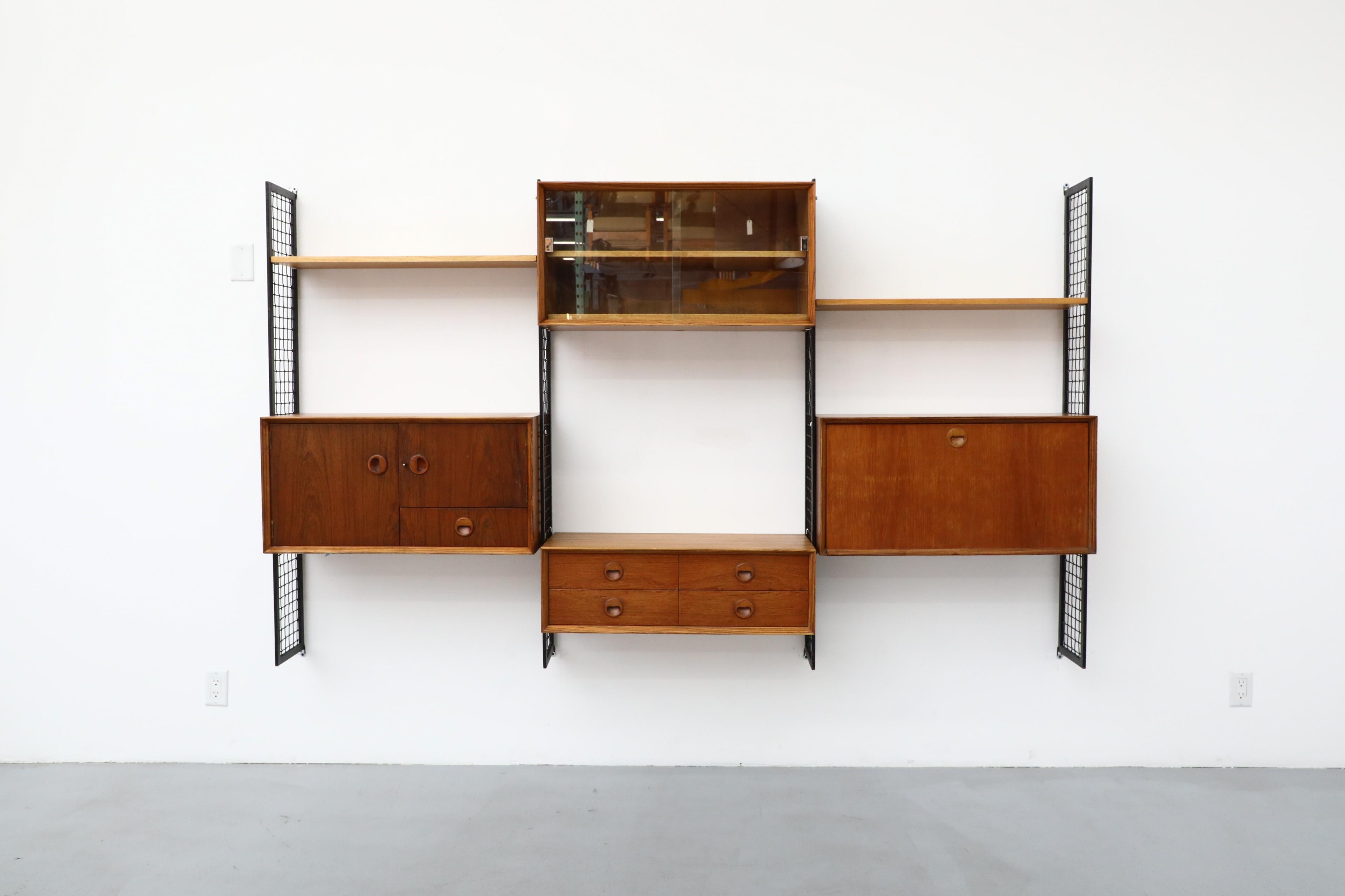 Mid-Century Modern Poul Cadovius Style Mixed Wood Wall Unit with Black Enameled Metal Grid Risers