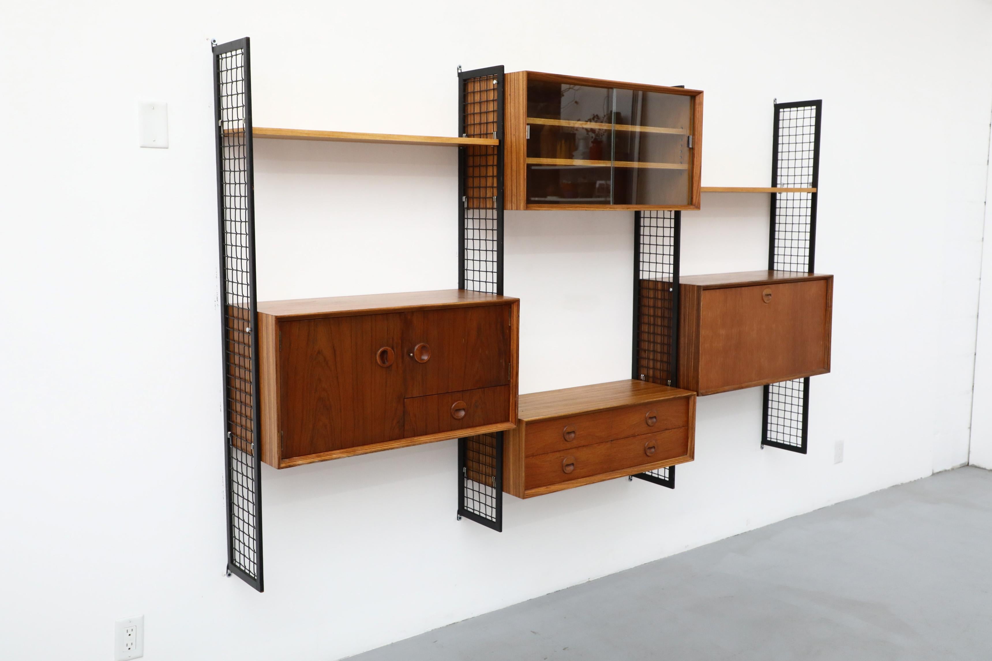 Poul Cadovius Style Mixed Wood Wall Unit with Black Enameled Metal Grid Risers In Good Condition In Los Angeles, CA