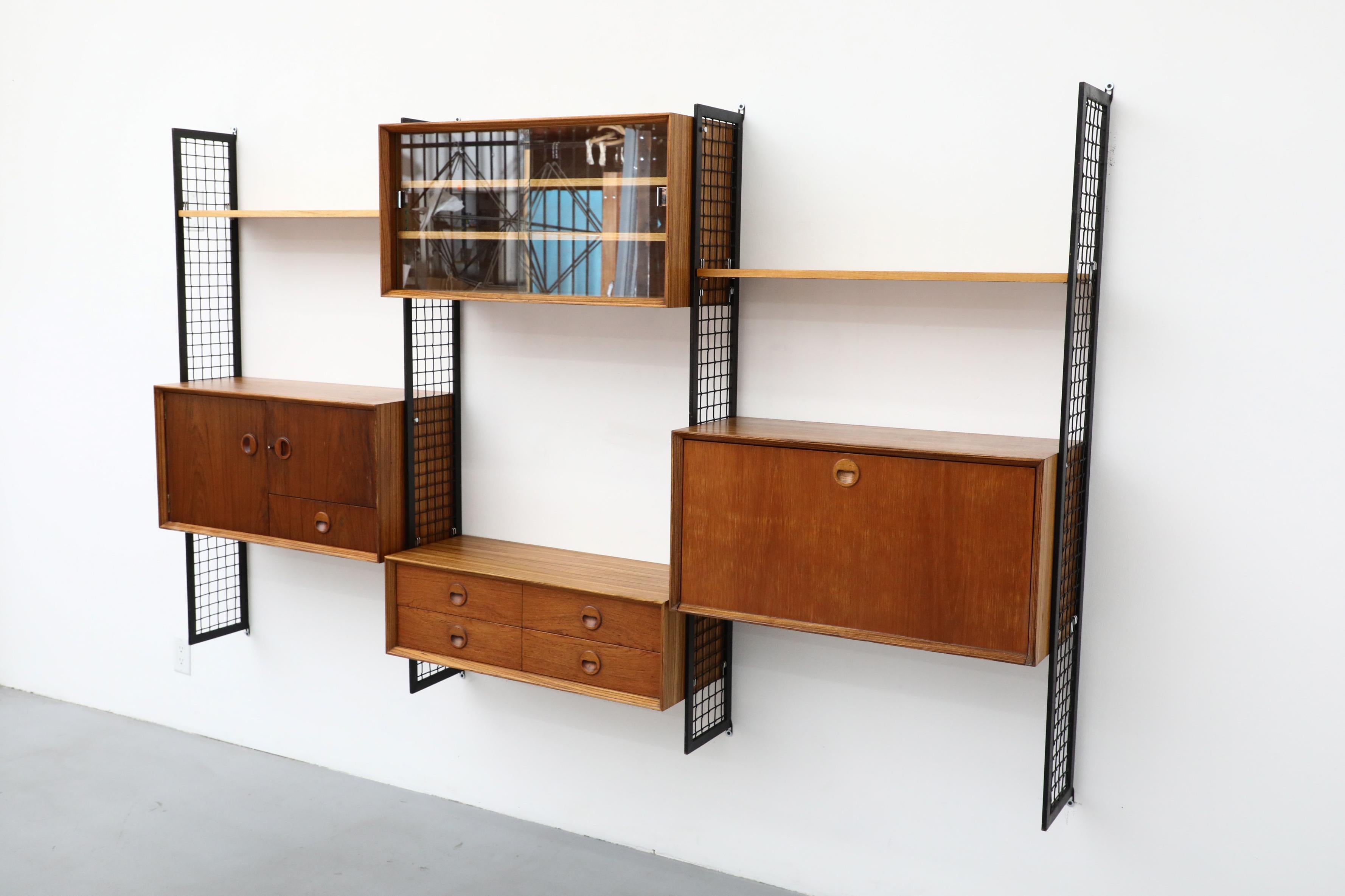 20th Century Poul Cadovius Style Mixed Wood Wall Unit with Black Enameled Metal Grid Risers