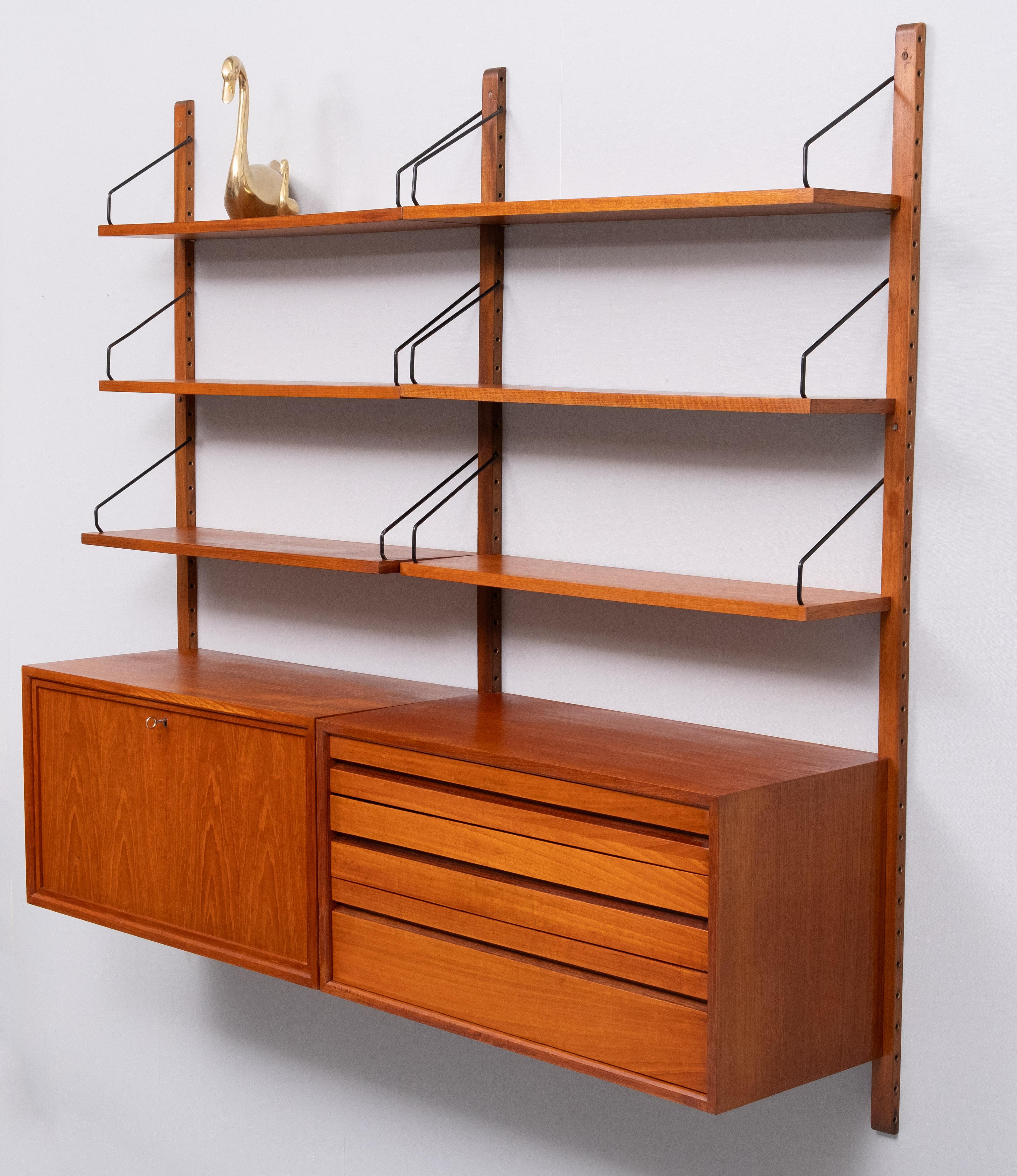 For sale this original Poul Cadovius wall system .Two cabinets 
One with Three drawers .And one with folding door Desk cabinet .
comes with 6 shelves . 3 Uprights and the hardware .Very nice 
Honey color Teak . Good condition . 