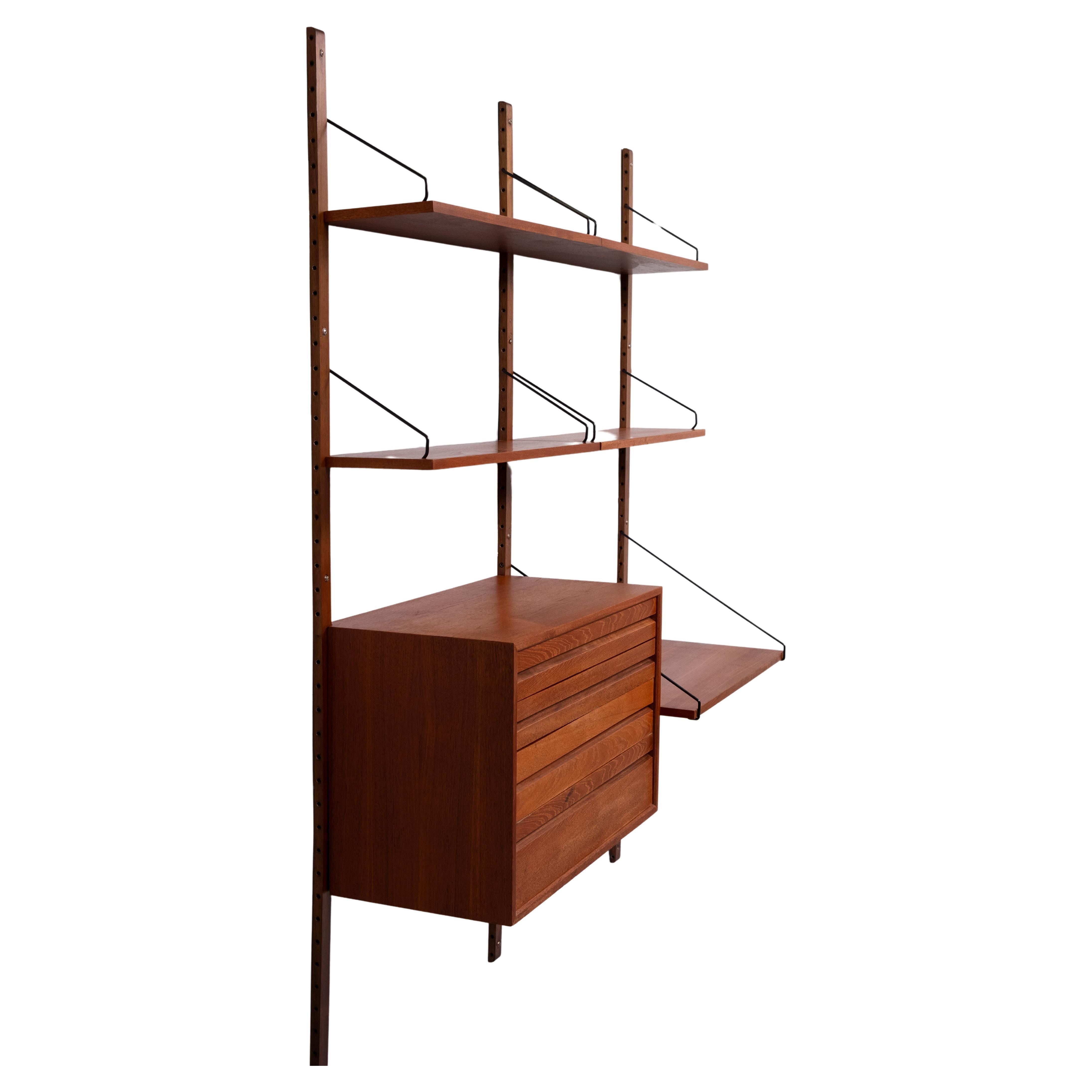 Iconic Poul Cadovius Royal System Wall unit .One large Teak 
Cabinet with 4 drawers . Five Shelves .One large one . 
Three uprights ,all the hardware This Wall system is ideal for a Home Office .
Takes very limited space . And looks great . Signed .
