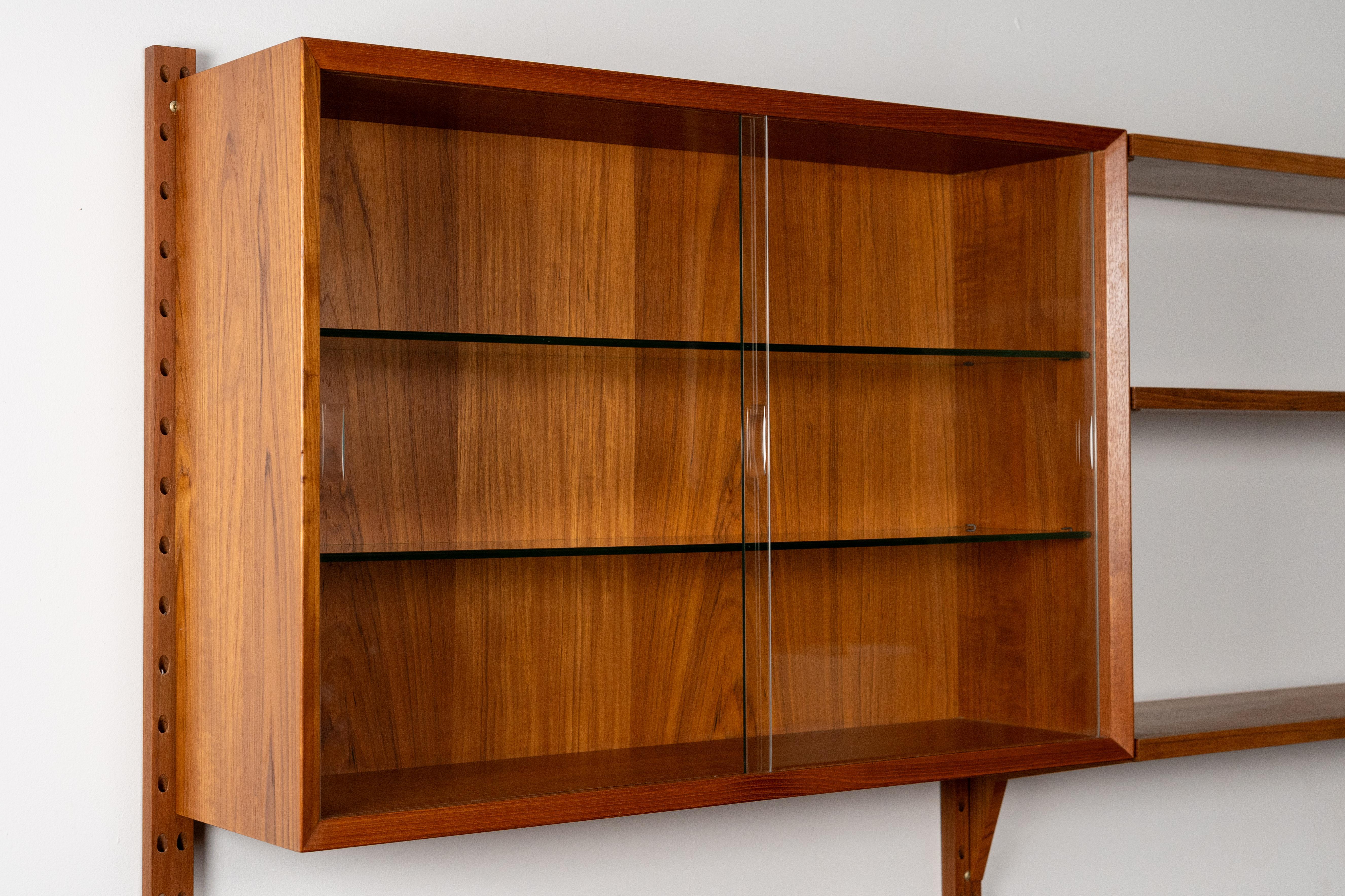 Denmark, ca. 1960s. A handsome and supremely functional CADO System - or “System CADO” as it was originally called - by Poul Cadovius. Features high quality teak construction with two wall-mounted bays - each consisting of various modular storage