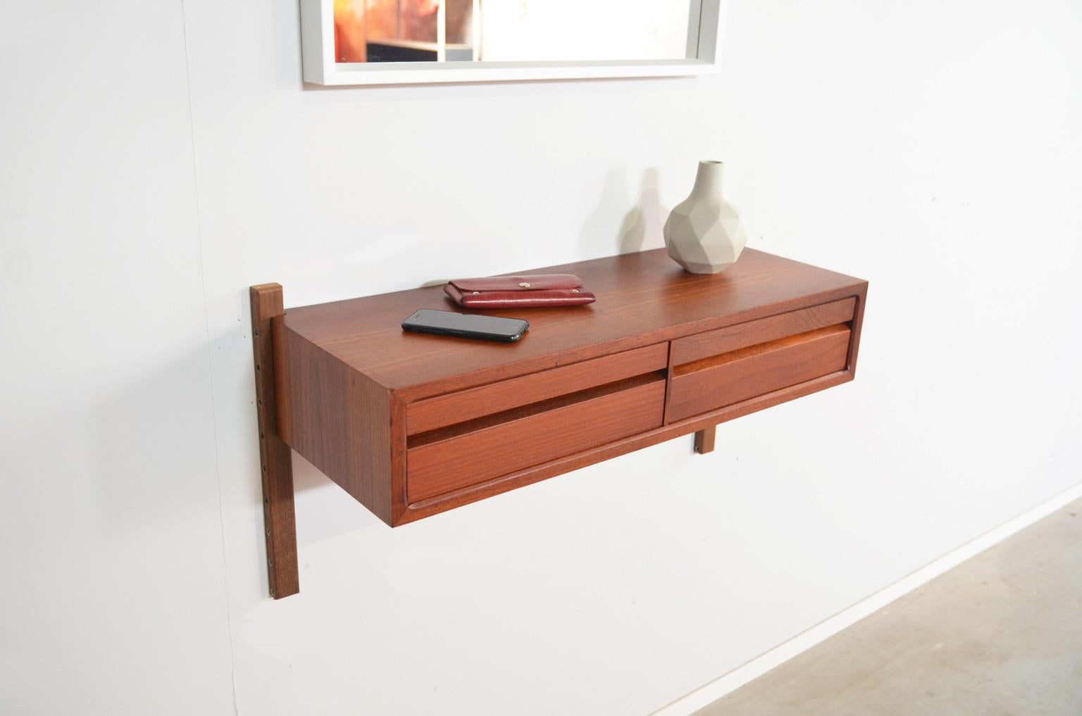 Wall console with two drawers by Poul Cadovius for Royal System, Denmark. The console is made of teak which has gained a beautiful and warm patina during the years.