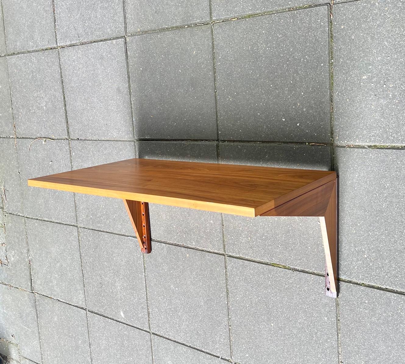 Sometimes less is more. Floating desk in teak designed by Poul Cadovius and made in Denmark for his own company Cado in the early part of the 1960s. It features a simple 5 parts construction with beautiful mirrored grain-work to the tabletop and