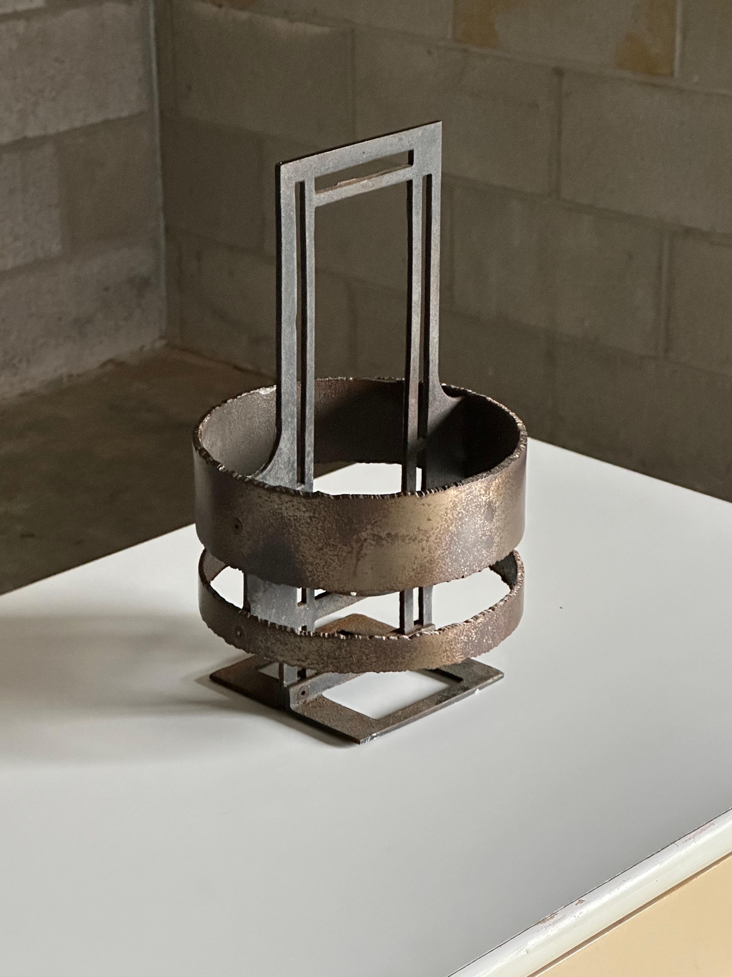 A rare freestanding Patinated iron and steel candle holder by Poul Havgaard with heavy brutalist influence. Features two steel rings on the outside and an iron frame. Marked on interior “Havgaard Danmark”

Matching pair of hanging versions of these