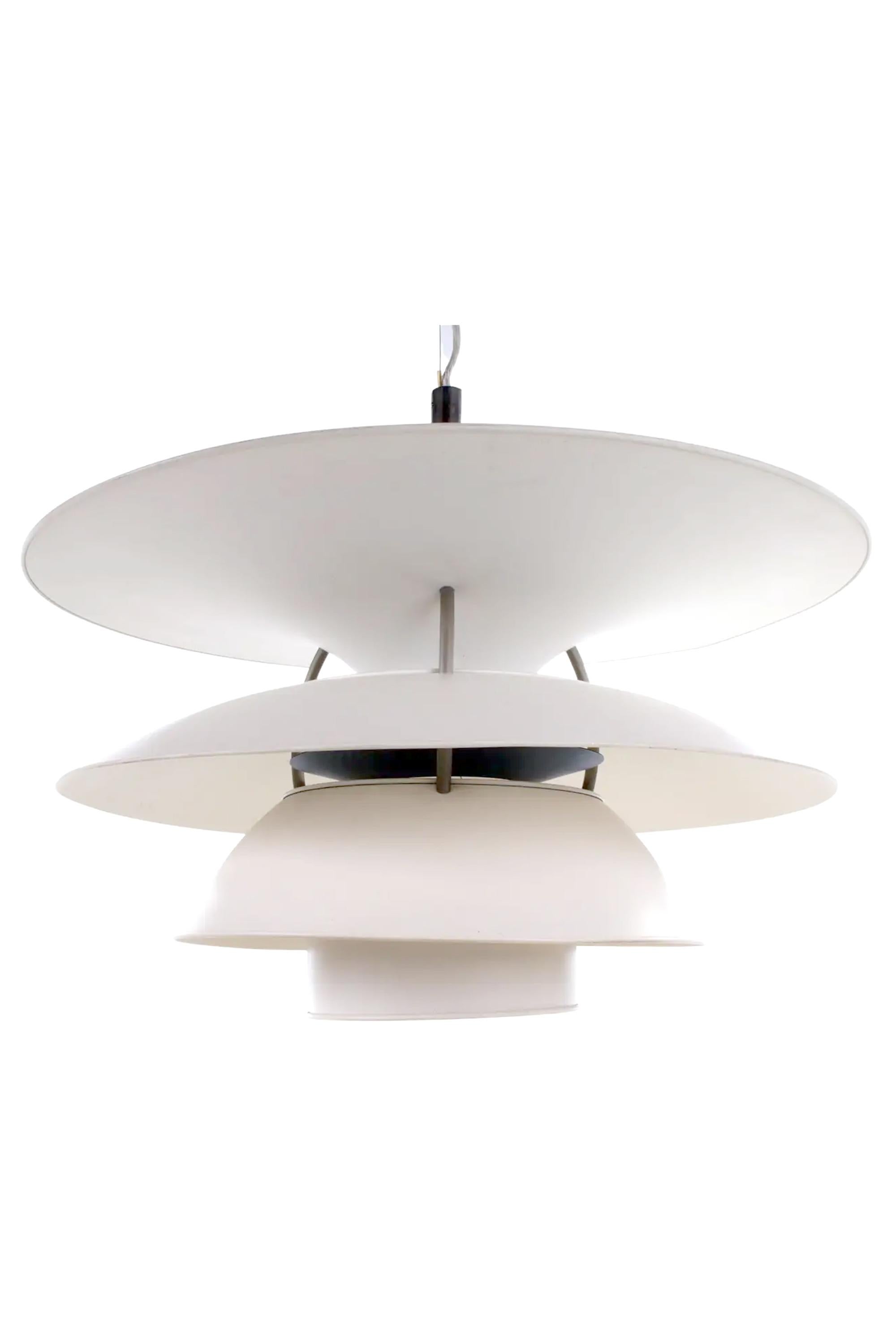 The Charlottenborg pendant lamp is a famous piece of Danish design. Designed by Poul Henningsen for the Danish company Louis Poulsen around the 1960s.

The lamp consists of four large white lampshades made of white lacquered metal and a smaller blue