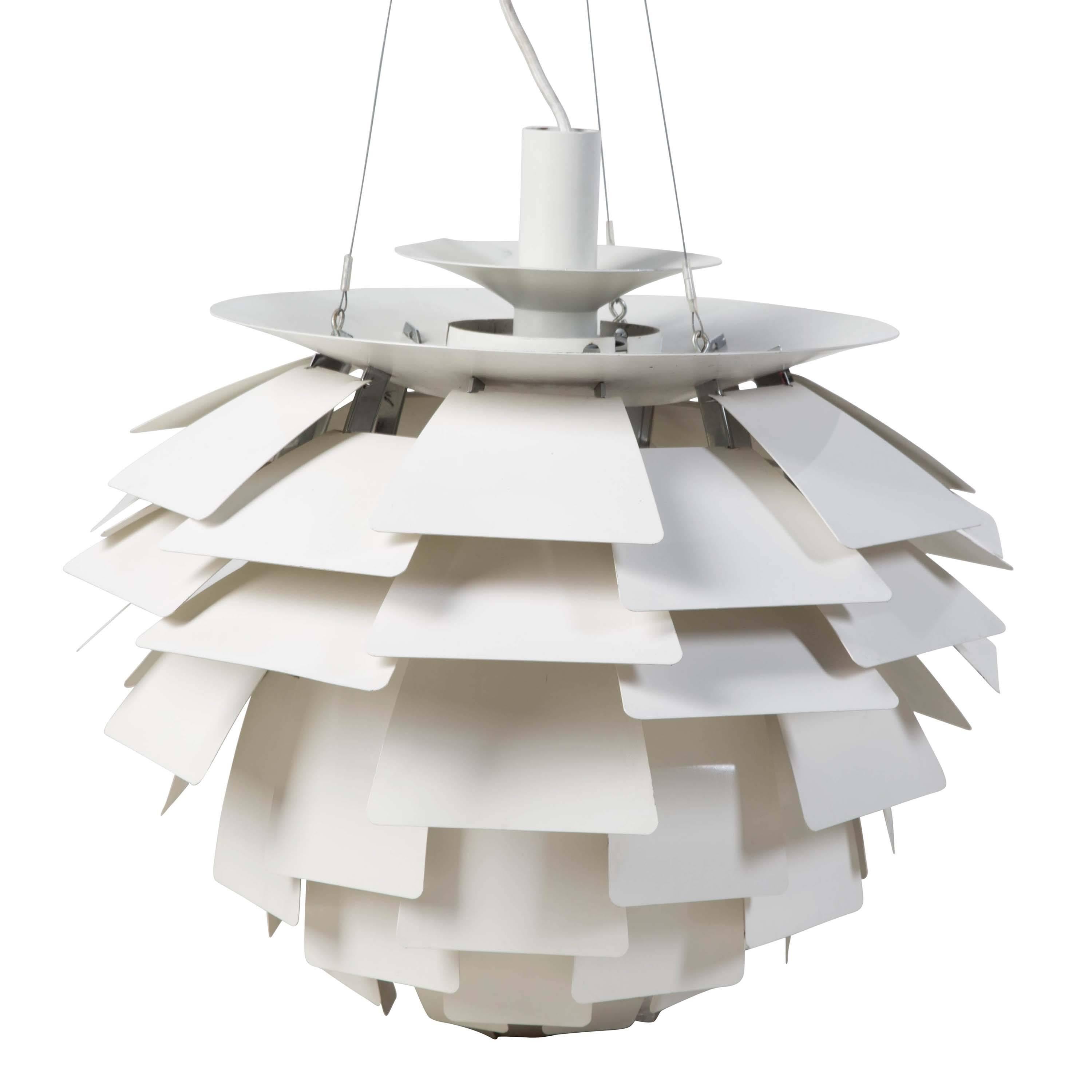A design icon dating from 1958, the PH Artichoke pendant light has 72 leaves in 12 circular rows, allowing the light to be viewed from any angle with out being able to see the light source. Designed in Denmark by Poul Henningsen for Louis Poulsen.
