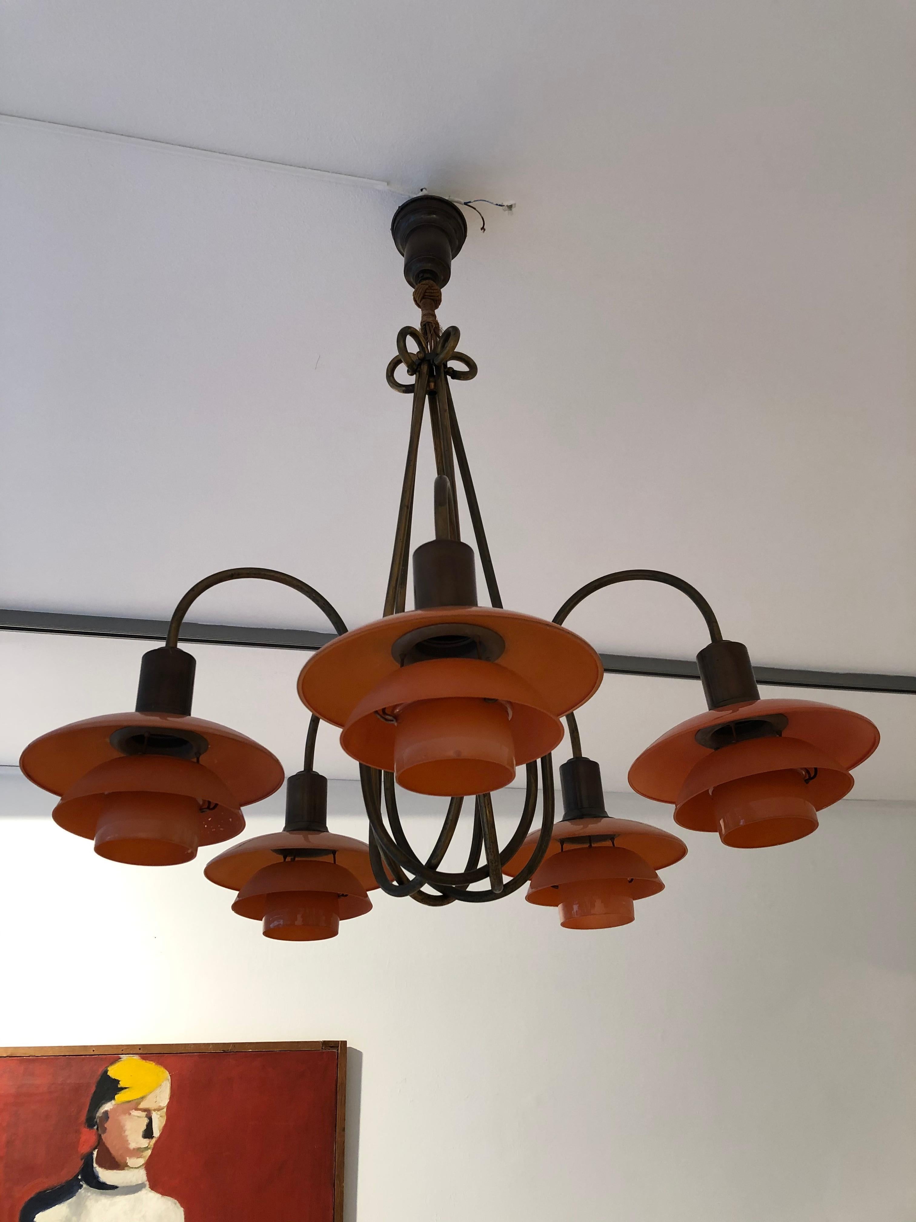 Poul Henningsen 'PH 2/2 Basket Crown' ceiling light. Five branches, patinated browned brass frame and socket houses, mounted with 2/2 red frosted glass shades. Each branch stamped 'PH-2' and 'Patented'. Manufactured by Louis Poulsen. Made in Denmark