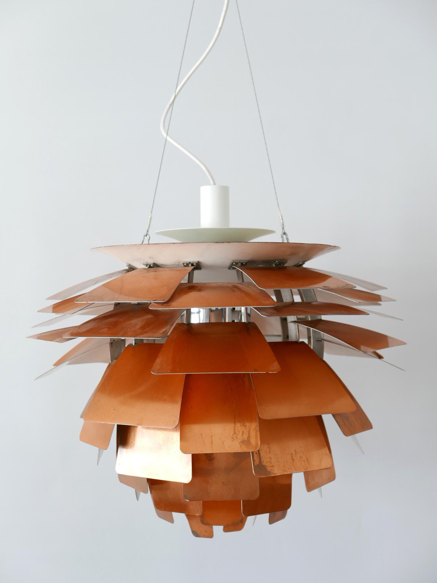 A 20th century iconic light design: PH 'Artichoke' chandelier / pendant lamp. This masterpiece is designed by Poul Henningsen in 1958 for Louis Poulsen, Denmark. Manufactured probably in early 2000s. Makers label inside the lamp shade and signed