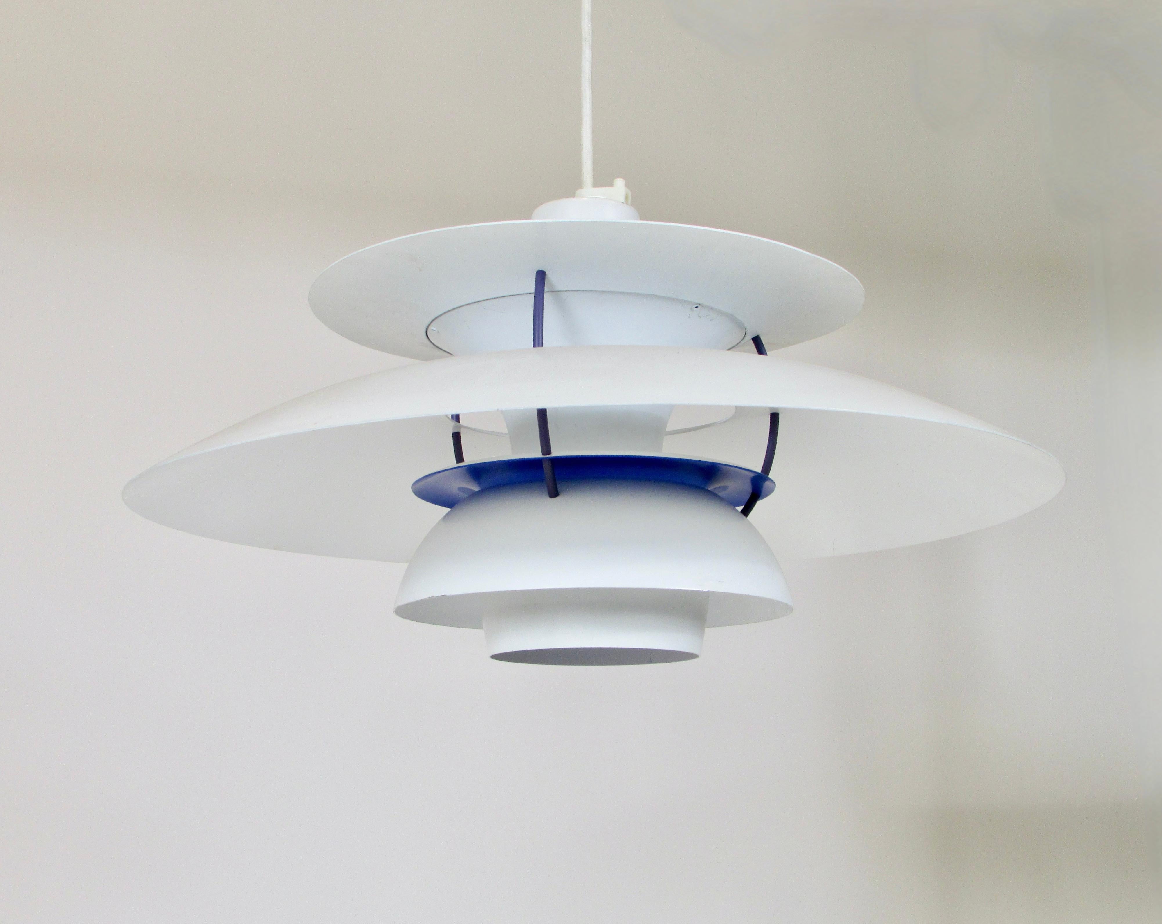 PH5 pendant by Poul Henningsen for Louis Poulsen Denmark. White with blue, iconic pendant by Poul Henningsen multiple levels of rounded aluminium create a soft shadow play. Most light falls downwards, but also horizontally there is a gentle light