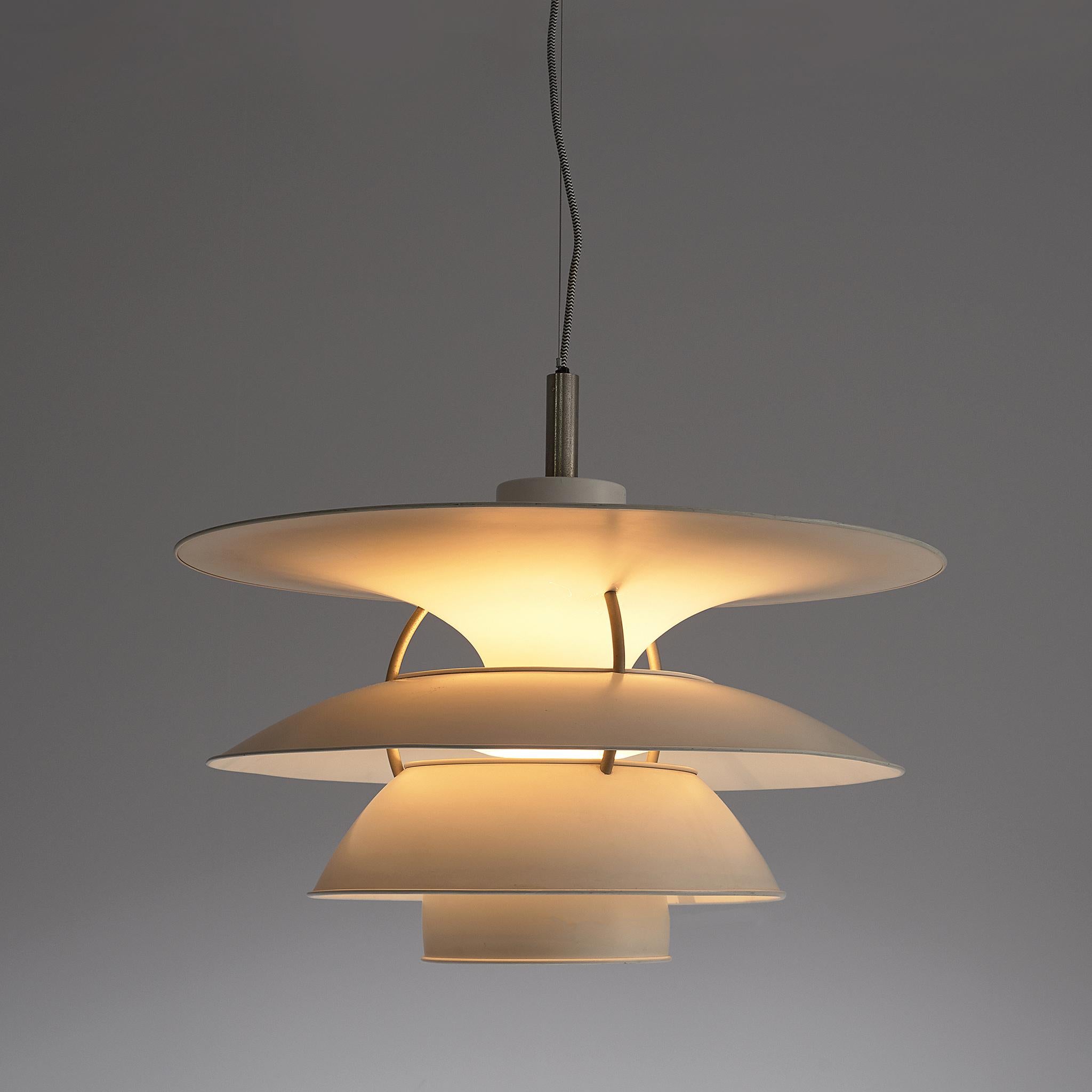 Charlottenburg' pendant, in metal, by Poul Henningsen for Louis Poulsen, Denmark, 1979.

White metal shades mounted on three steel ribs. The shades are designed for horizontal and vertical surfaces to indirectly illuminate a room. Provides a