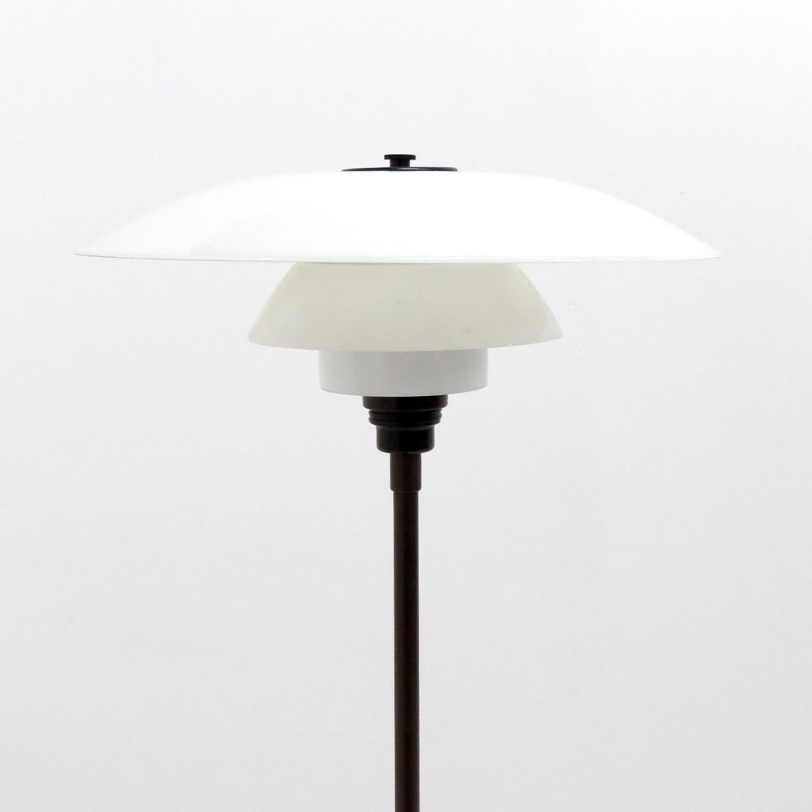 Rare, early floor lamp by Poul Henningsen for Louis Poulsen with two layer opaline glass PH 4/3 shade set, bakelite socket and cover plate. The lamp is wired for US standards with brown cloth cord and a foot switch, one E27 socket, max. Wattage 100w