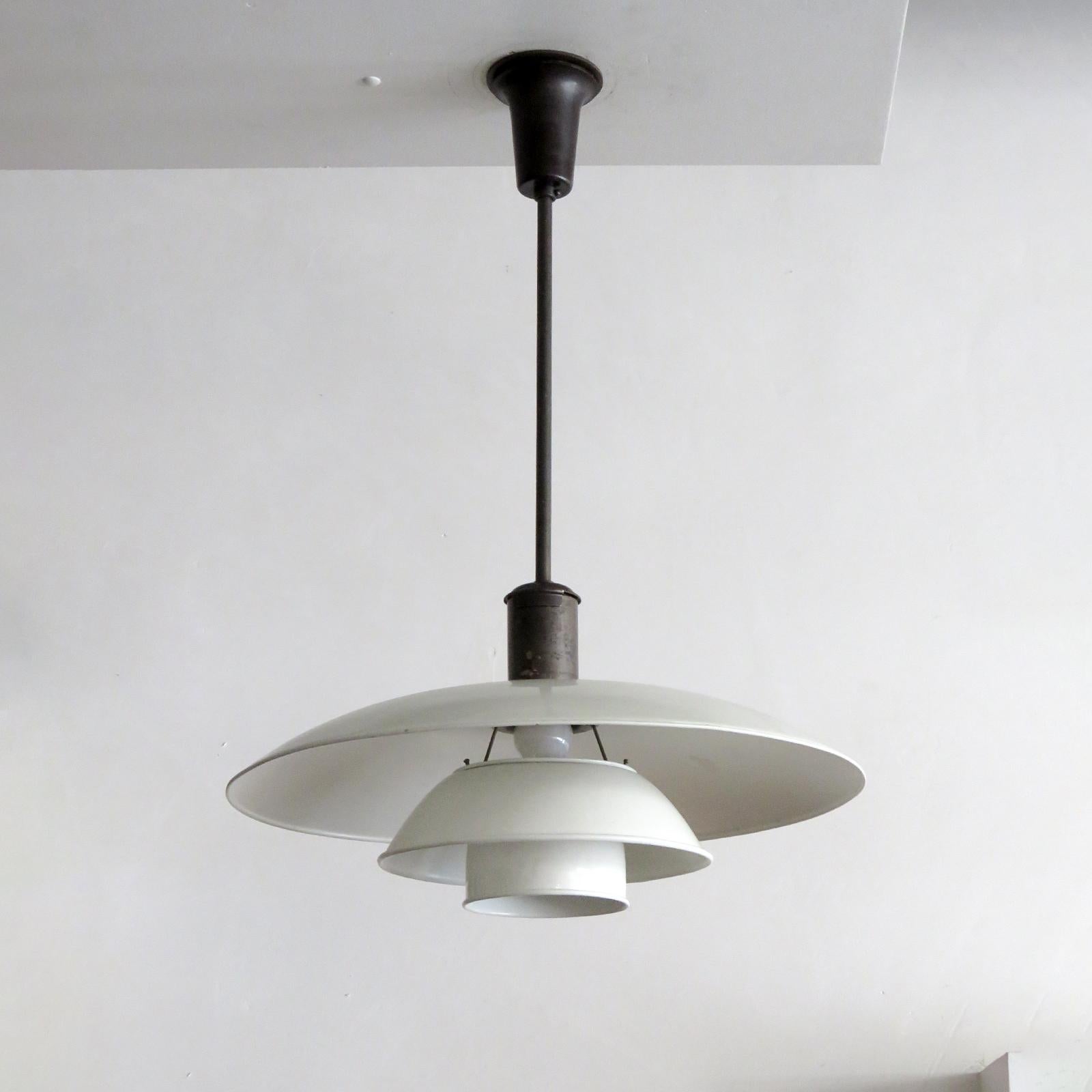 wonderful early 1930's PH 5/4 Pendant by Poul Henningsen for Louis Poulsen with white enameled metal shade set, patinaed brass bayonet shade holder and bakelite canopy, stamped ph-4 patented, some dents and wear, wired for US standards, one E27