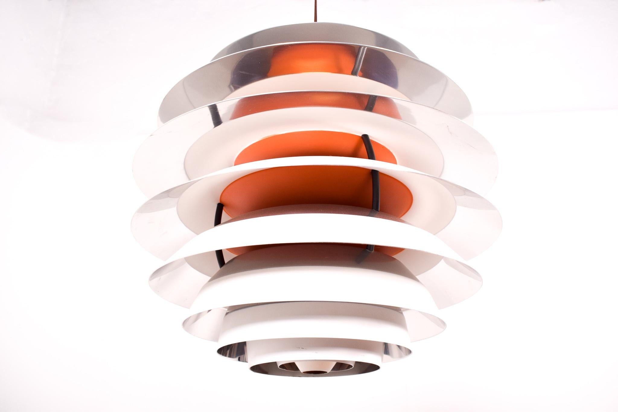 Pendant light, model Kontrast, designed in 1960 by Poul Henningsen for Louis Poulsen. Made of aluminium ten aluminium shades held together with three steel supports. The lightbulb inside the lamp can be moved up and down. This ability to adjust the