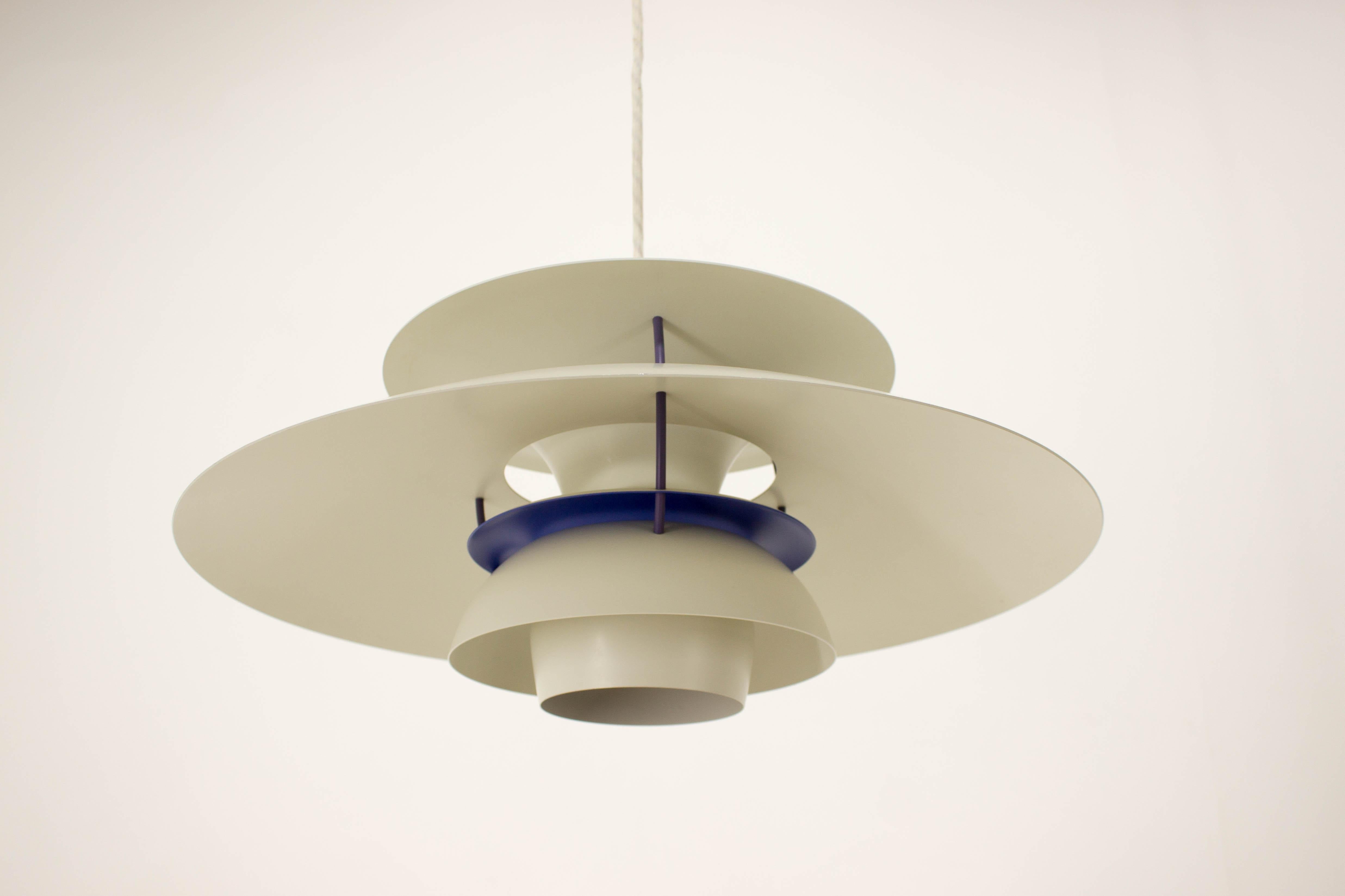 One of the most famous light by Poul Henningsen, designed for Louis Poulsen, Denmark. This piece of matte white-enameled aluminum lamp is accentuated with royal blue and red details creating wide range of subtile shades of these colors. Very good