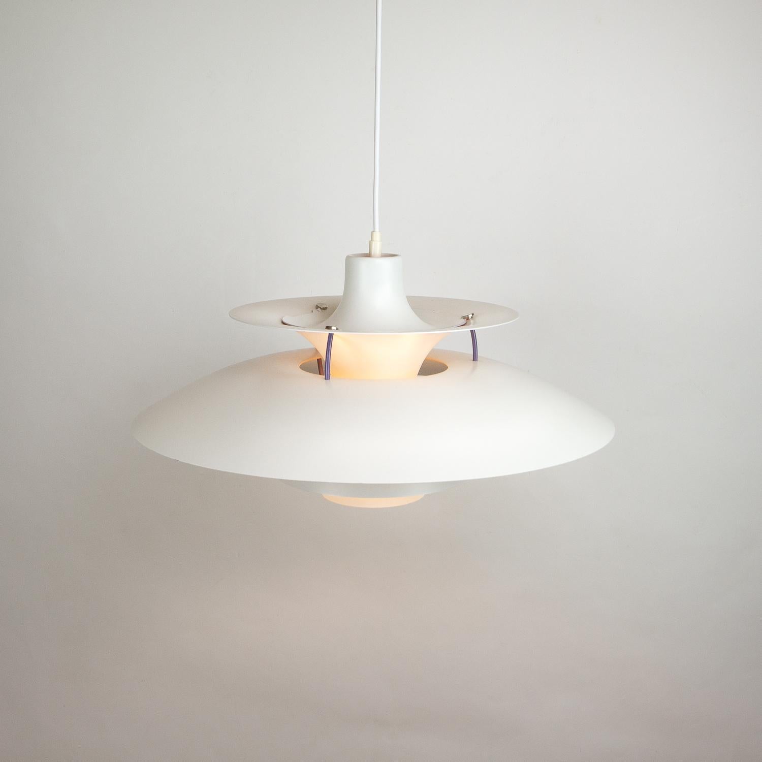 Designed by Poul Henningsen for Louis Poulsen in 1958. The PH5 is designed to be hung low over a table and disperses the light in a non-glare manner. Excellent vintage condition, Denmark, 1960s-1970s. We have 2 available in white.