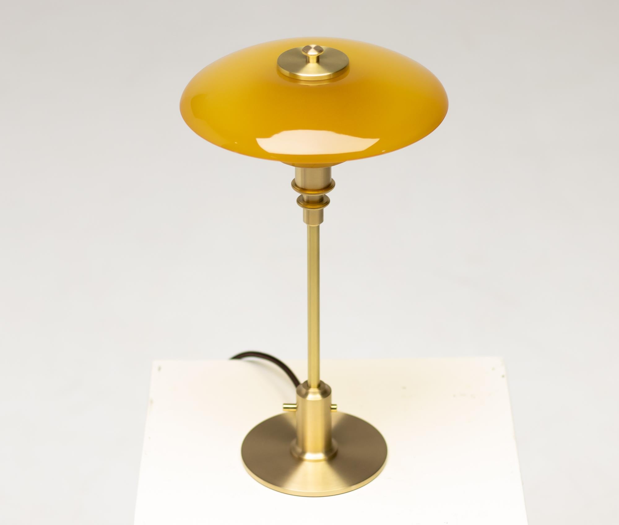 Limited edition table lamp model PH 2/1 with amber glass designed by Poul Henningsen.
Produced by Louis Poulsen in Denmark. Marked Louis Poulsen at the bottom.
PH 2/1 is designed on the principle of a reflecting multi-shade system, creating