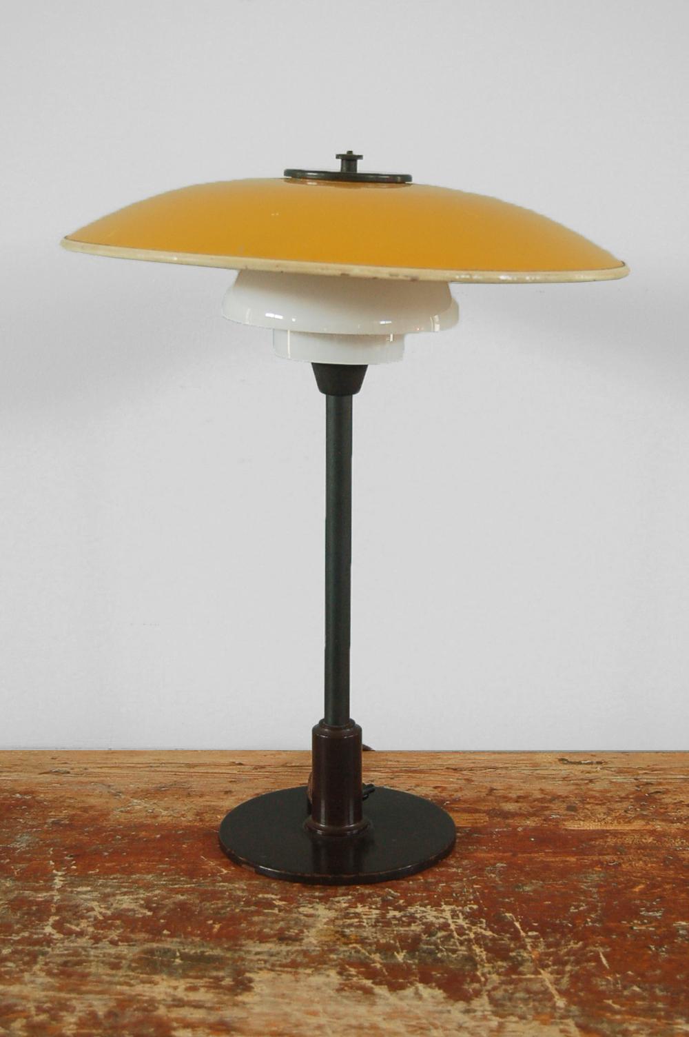 Poul Henningsen (1894 Ordrup, Denmark - Hillerød, Denmark 1967), table light 3/2 yellow or white metal top shade with opal white glass middle and lower shades, patinated metal components, manufactured by Louis Poulsen, Copenhagen, Denmark, origin: