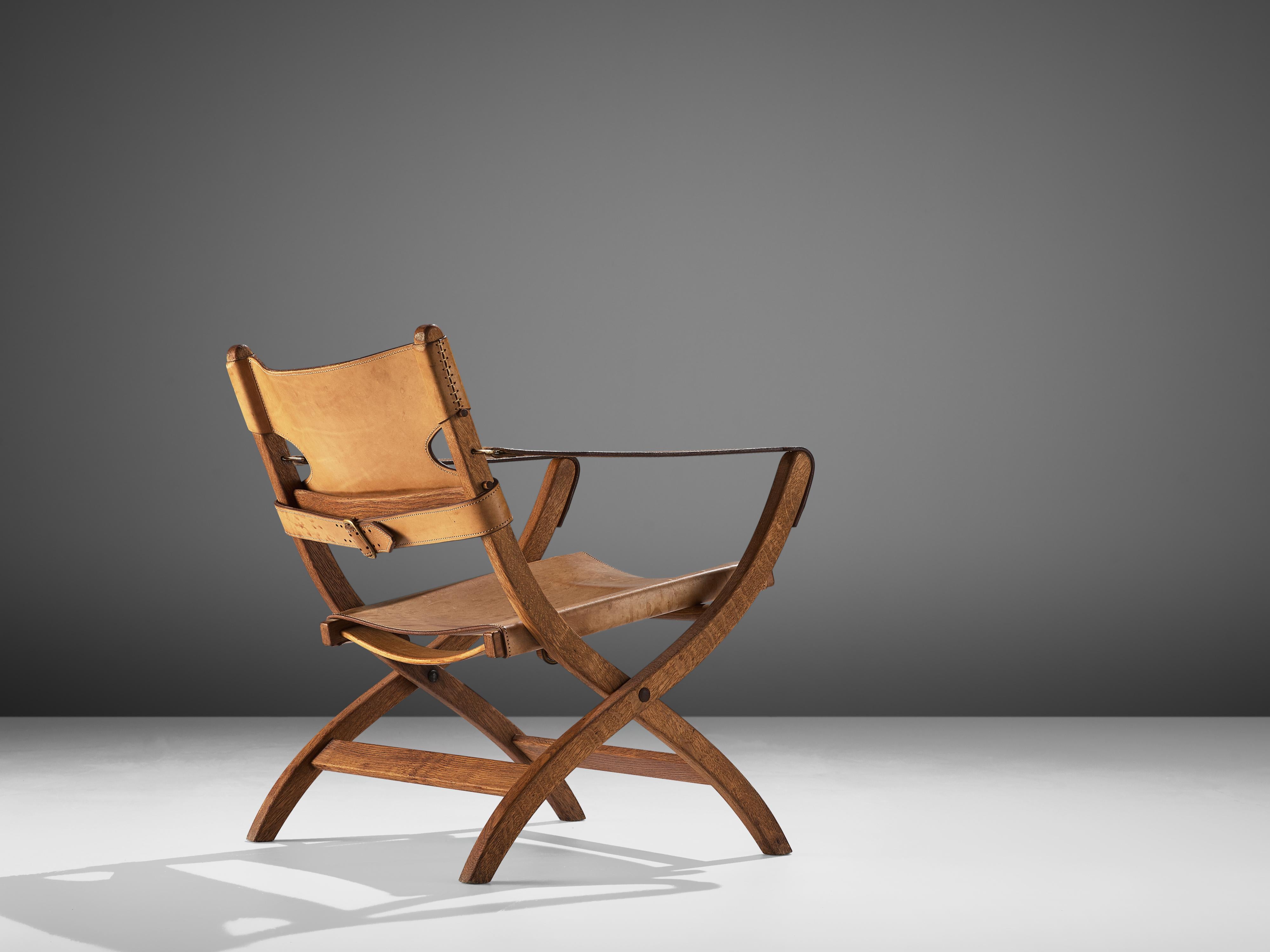 Poul Hundevad, foldable armchair, oak, leather, Denmark, 1950s.

This folding chair has X-shaped legs, and is inspired on ancient Egyptian thrones and chairs. The frame is from solid oak. The seating and back are made of cognac colored to beige