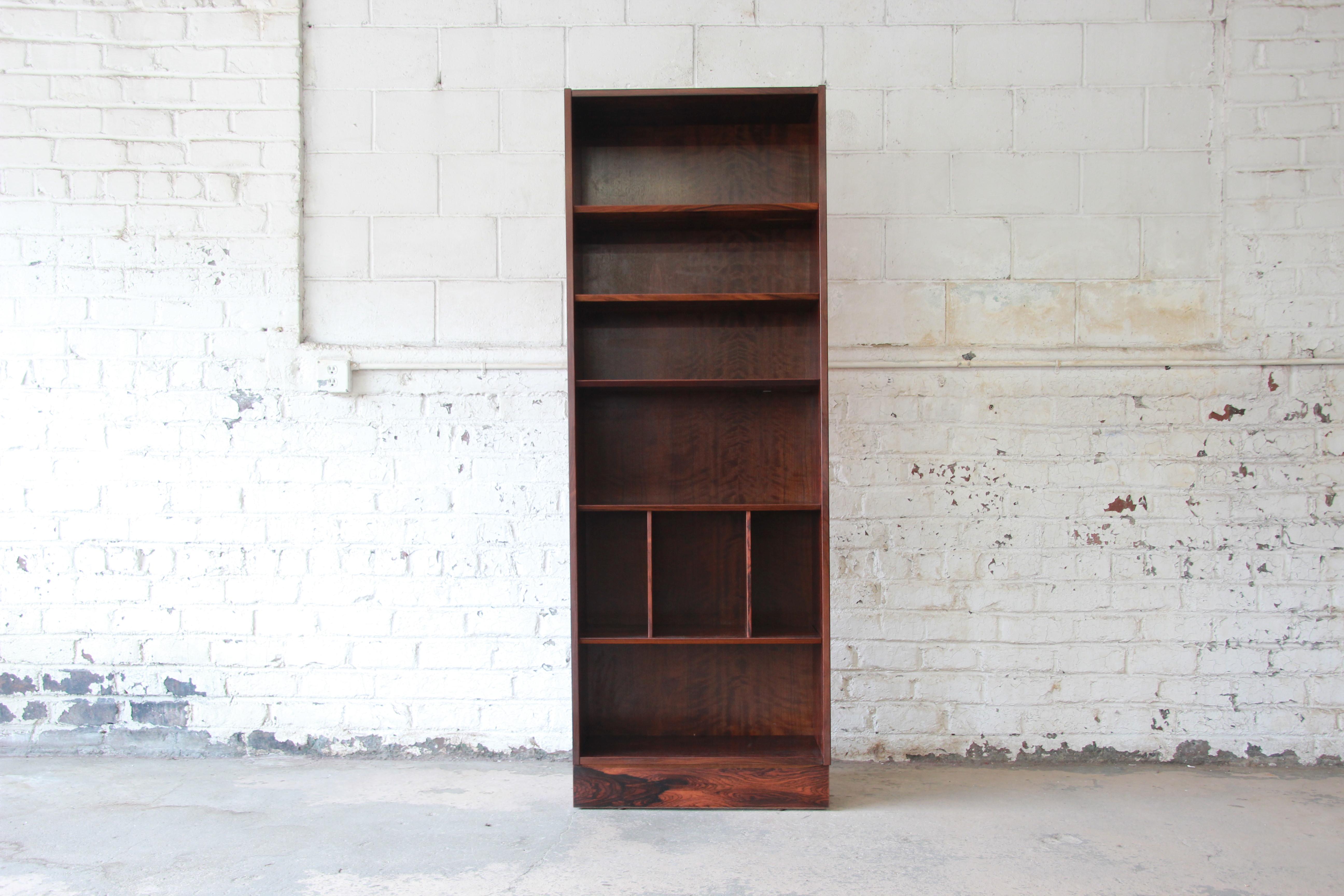 Offering an exceptional rosewood Danish modern bookcase by Paul Hundevad. This Scandinavian piece has six areas to hold your book collection or display your items. The lower portion of the bookcase offers two dividers in one of the sections as a