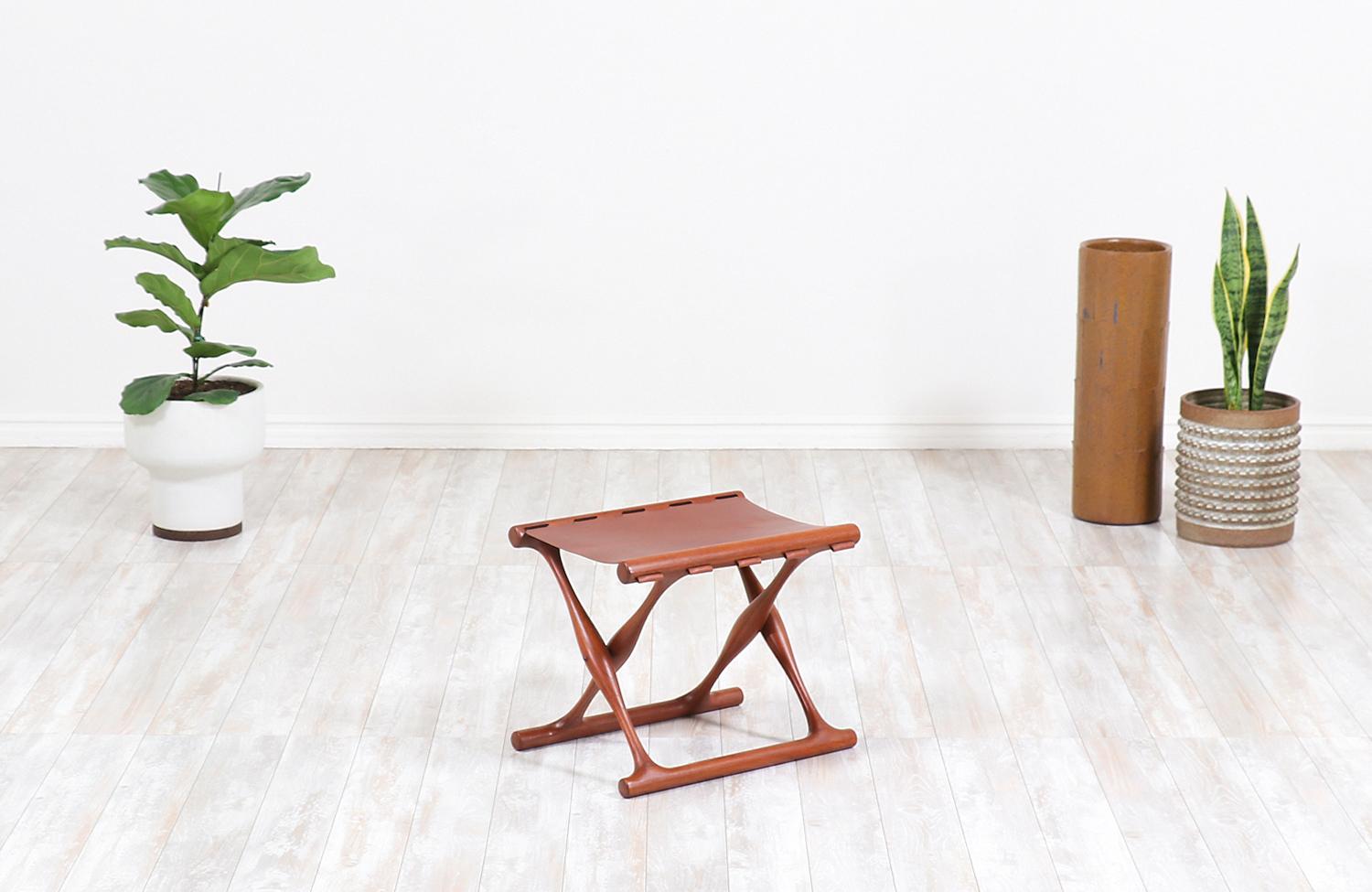 Iconic “Gold Hill” folding stool designed by Poul Hundevad for Vamdrup Stolefabrik in Denmark, circa 1950s. This beautiful Danish modern stool is known to be inspired in a design dated back from the Scandinavian Bronze Age, in which an example is