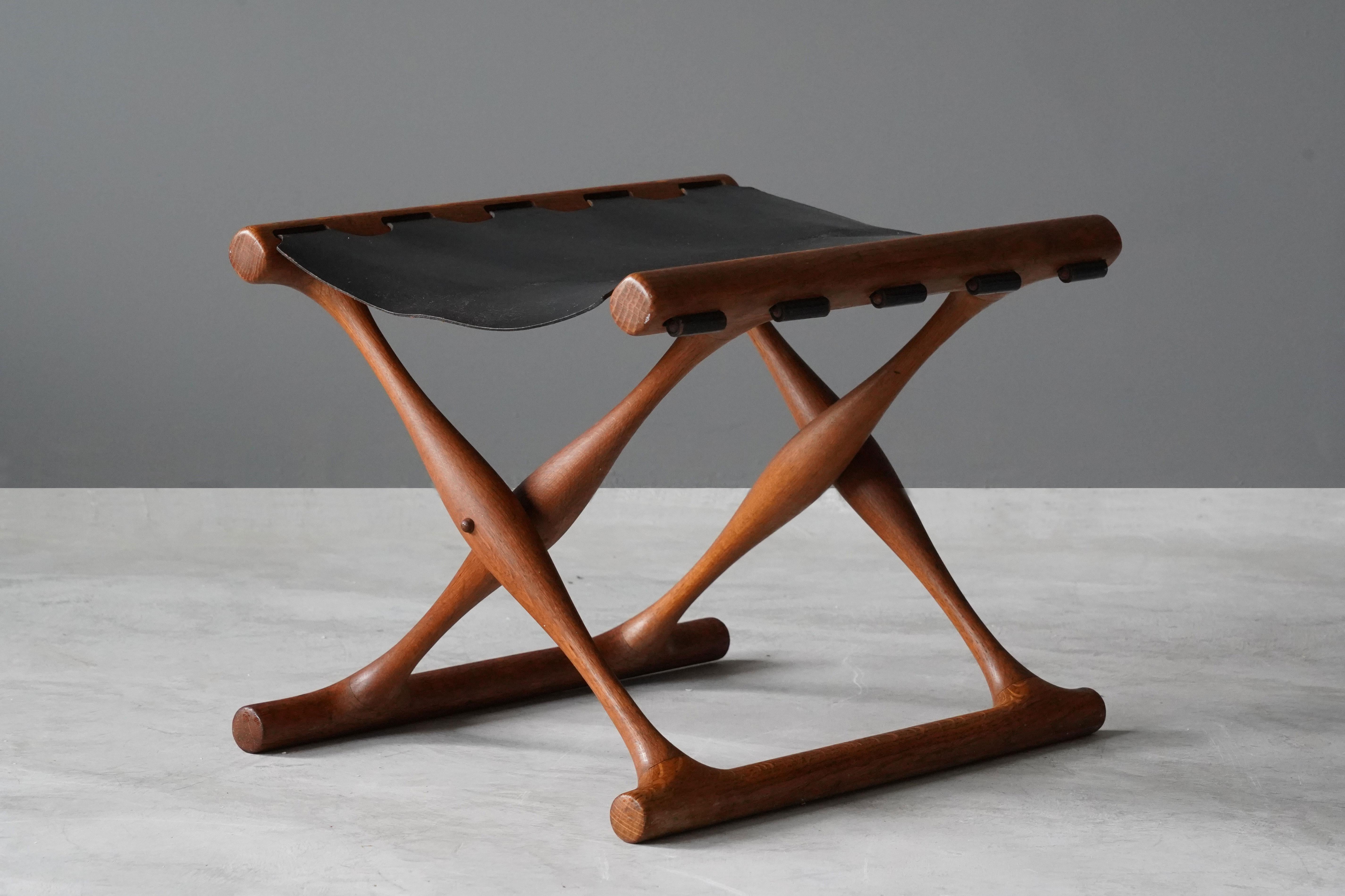 An early production “Guldhøj” folding stool, designed by Poul Hundevad and produced in the studio of the artist. Executed in finely sculpted oak and original black leather. 

Other designers of the period include Kaare Klint, Ole Wanscher, Finn