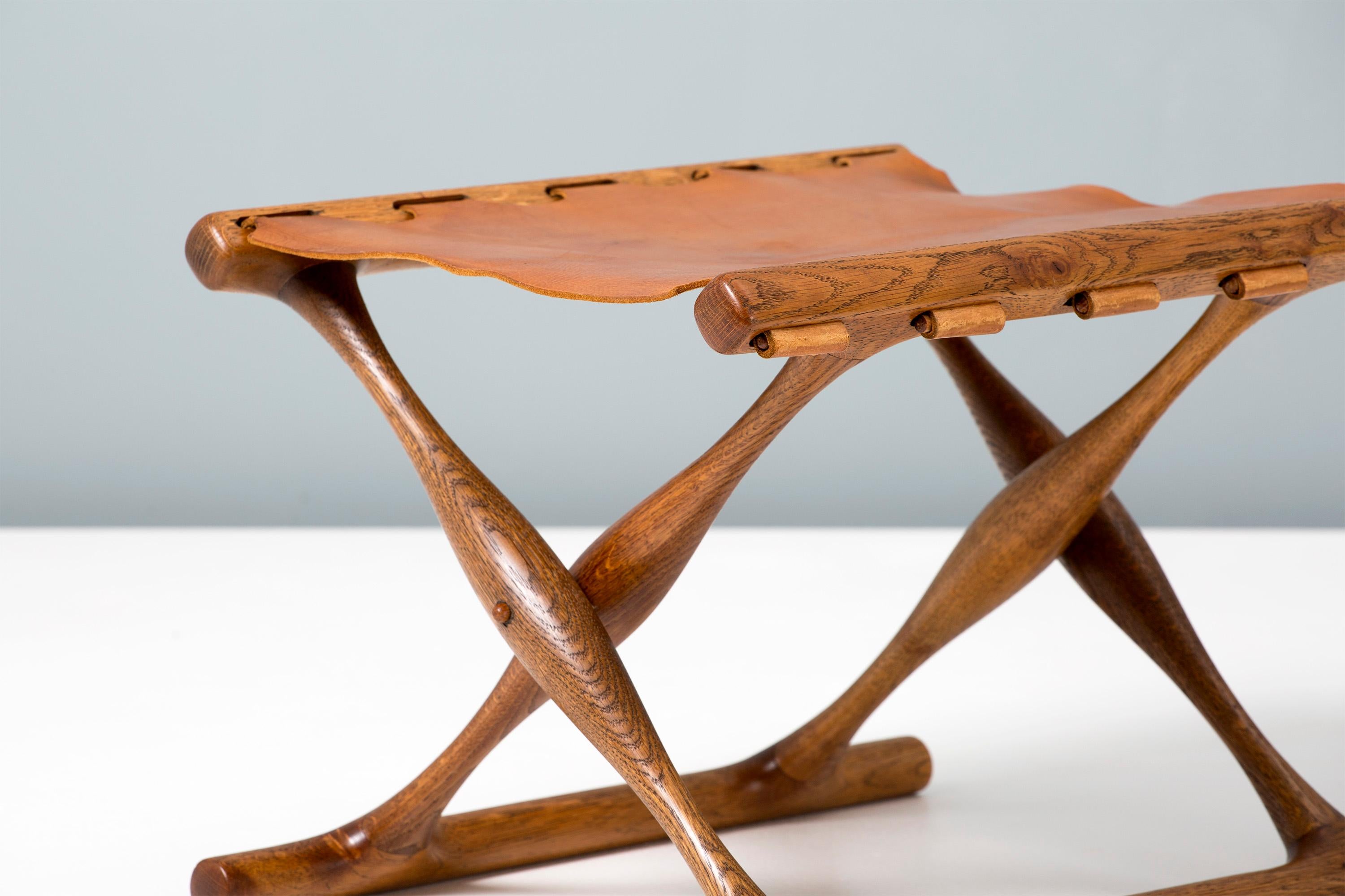 Poul Hundevad

Guldhoj folding stool, 1948

The iconic model 41 folding stool in beautifully aged Danish oak with original, patinated cognac brown saddle leather seat. The Guldhoj stool was designed as a replica of a Bronze Age artefact found in