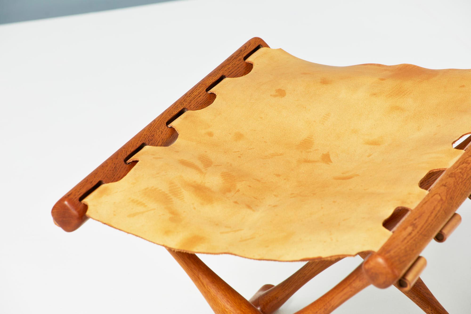 Poul Hundevad

Guldhoj folding stool, 1948

The iconic model 41 folding stool in beautifully aged Danish oak with original, patinated cognac brown saddle leather seat. The Guldhoj stool was designed as a replica of a Bronze Age artefact found in