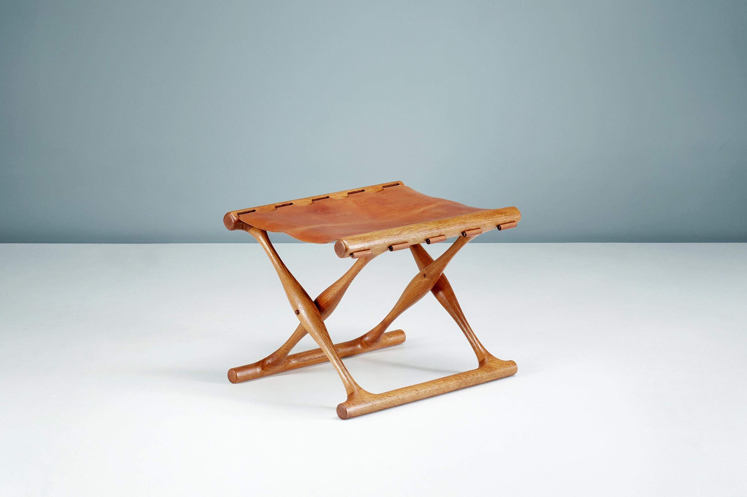 Poul Hundevad - Guldhoj Folding Stool, 1948

The iconic model 41 folding stool in beautifully aged Danish oak with original, patinated cognac brown saddle leather seat. The Guldhoj stool was designed as a replica of a Bronze Age artefact found in