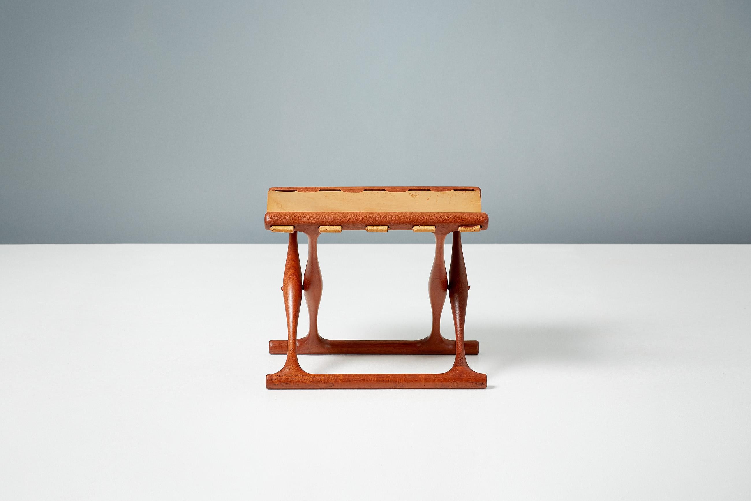 Poul Hundevad

Guldhoj folding stool, 1948

The iconic model 41 folding stool in beautifully aged teak wood with original, patinated cognac brown saddle leather seat. The Guldhoj stool was designed as a replica of a Bronze Age artefact found in