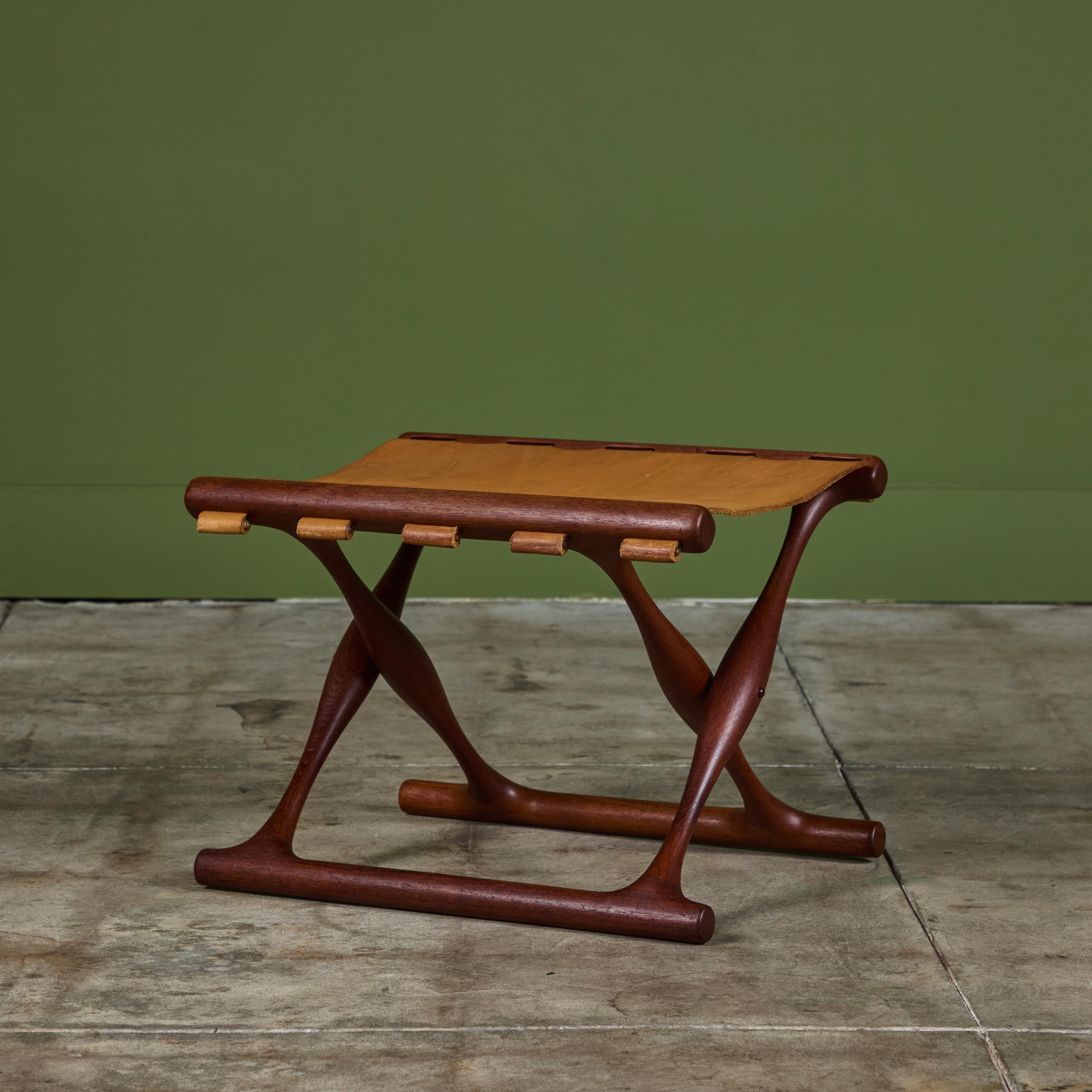 Leather folding stool designed by Poul Hundevad for Vamdrup Stolefabrik, c.1950s, Denmark. The stool features a solid teak frame and tan leather sling seat secured by wooden dowels. The stool can easily be folded for storage or easy